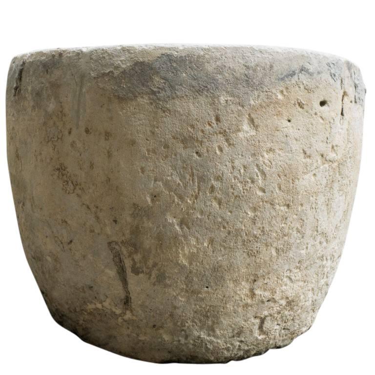 A limestone planter rich in color and texture, once a water vessel from Indonesia now a lovely addition for a landscape design or interior decorating enthusiast. A patina of mineral deposits highlight the already vibrant natural tones that adorn the