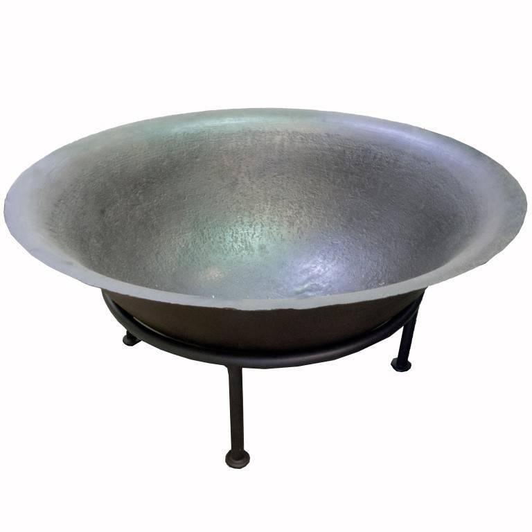 Created in the 19th century in Java, Indonesia this cast iron vessel is shaped like a giant bowl. The bowl itself is 13 inches deep and is crafted with an elegant curve that gives way to an outward flattening top rim. With the stand the vessel is 20