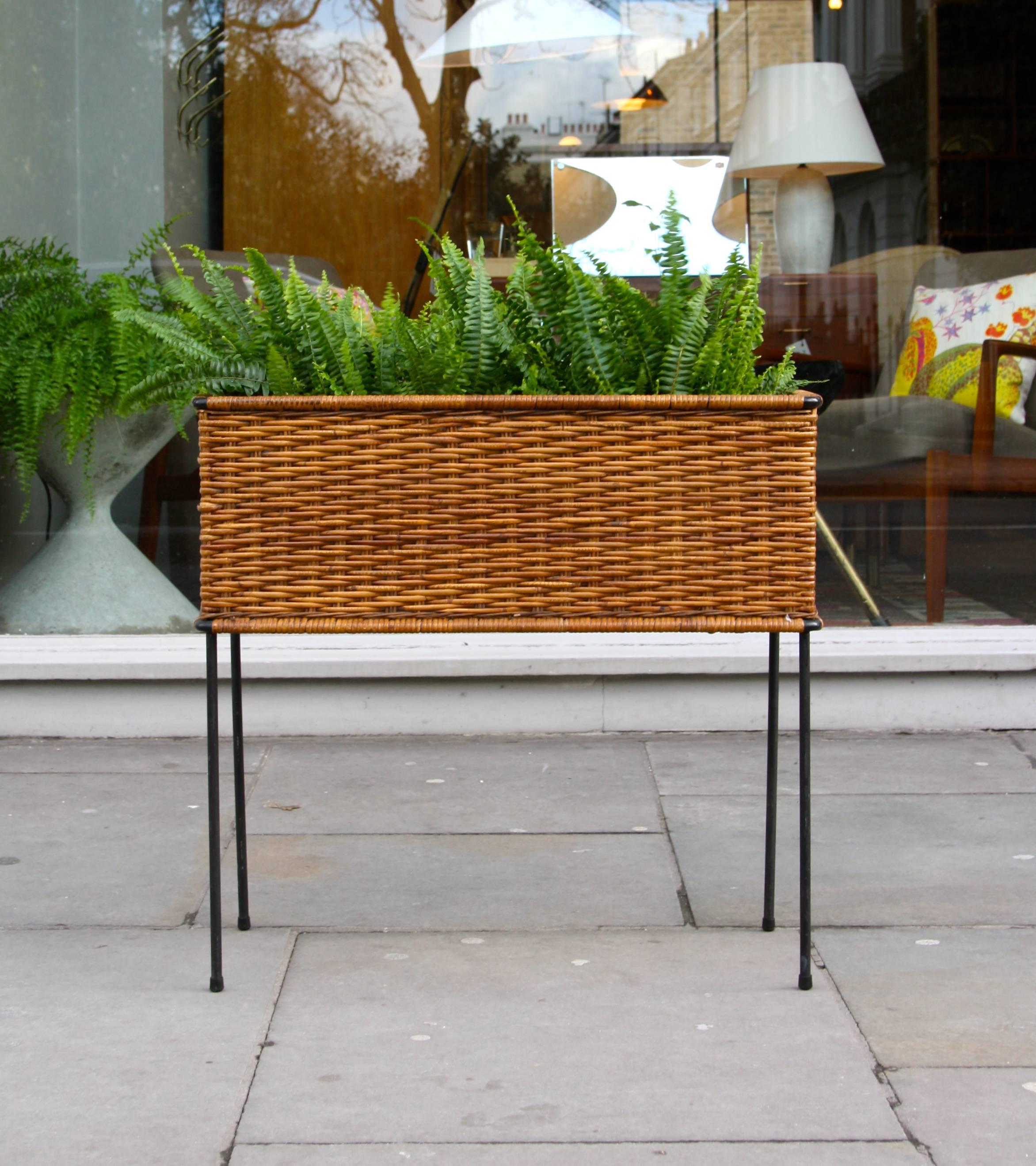High planter with the original wicker by Carl Auböck. Black painted metal frame and internal liner in zinc.