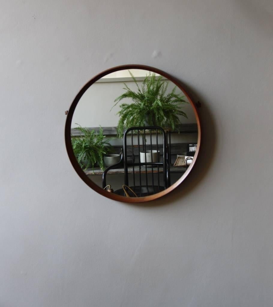 Vintage round mirror made in Denmark in circa 1950. The frame, tapered at a point at the front, is made of seven sections of rosewood joined through finger joints. It hangs with a leather strap on the back. In excellent condition.