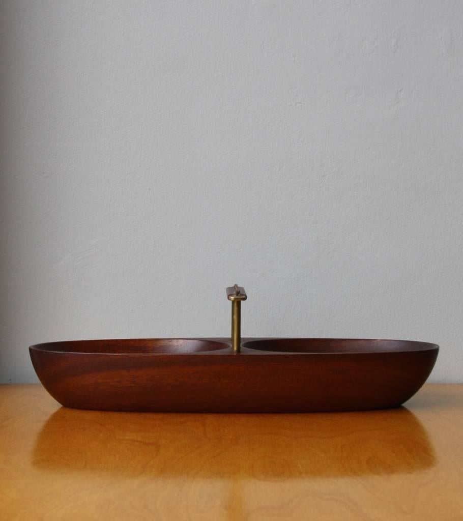 Nut bowl in carved mahogany with a brass square handle covered in leather. Designed and made in the Carl Auböck werkstätte, Vienna, circa 1950.
In overall excellent condition.