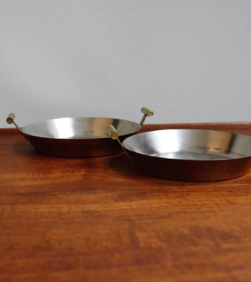 Pair of vintage pans by Carl Auböck II, Vienna, circa 1950. 
Made in steel and copper, they have cast brass handles. 
In overall very good condition, both are stamped 'Auböck MADE IN AUSTRIA' on the brass handle.