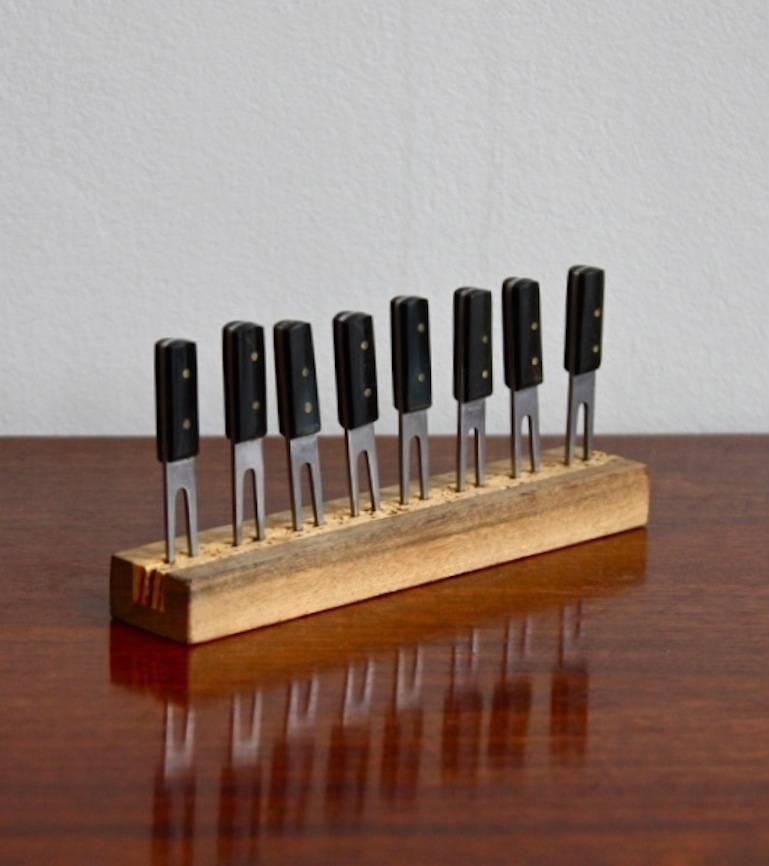 Set of corn on the cob holders by Carl Auböck with Horn handles set in a walnut holder.