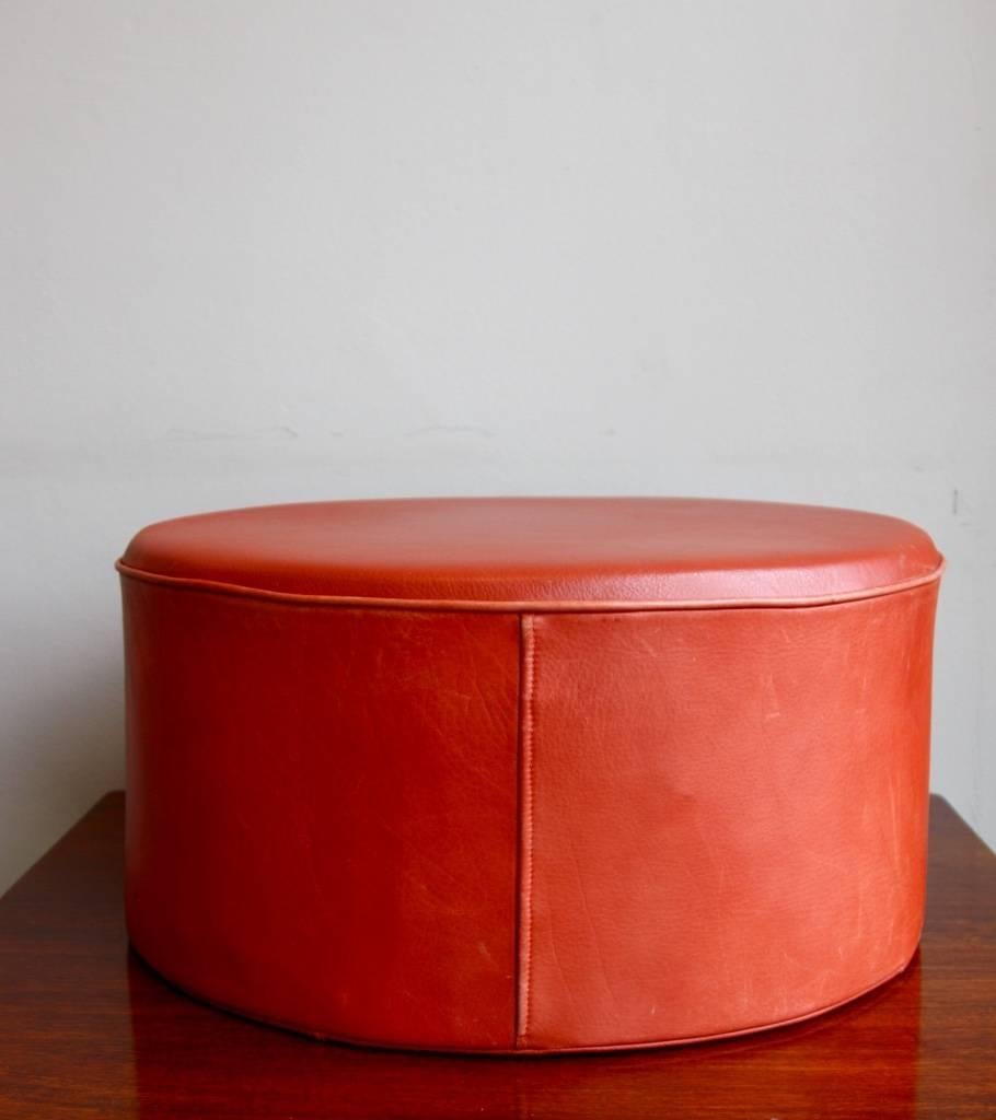 Cylindrical foot stool in red leather designed and made by Ivan Schlechter, the leather maker who made all of the early Kjaerholm pieces. The latter was known for being very selective in choosing the persons working for him.