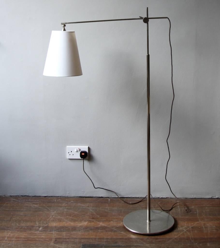 Floor lamp by Le Klint in matte nickel-plated brass, designed and made in Denmark in the 1940s.
 
The arm slides through the supporting bracket on the stem; its direction can be adjusted as well as the height of the bracket itself. This, together