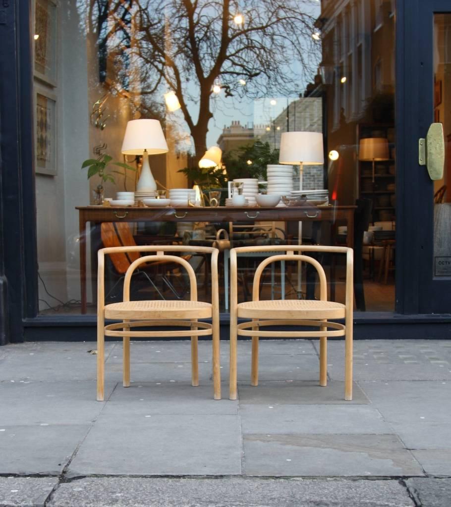 Pair of PK 15 armchairs in ash with woven cane seat designed by Paul Kjaerholm in 1979 and made by PP Møbler in the 1990s.
The sinuous frame is obtained using the precompression, an evolution of the older technique of steam bending. 
The PK 15 was