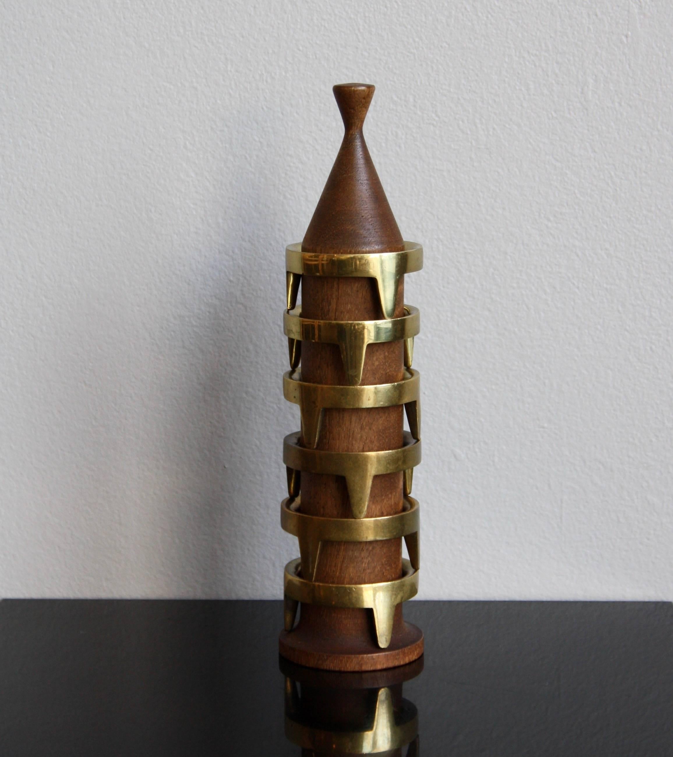 A vintage set of six solid sand-cast brass egg cups and their walnut tower. Designed and made by Carl Auböck II in Vienna, Austria circa 1950. Each egg holder -which could also be used as a napkin ring- boasts a deep and even patina and is stamped
