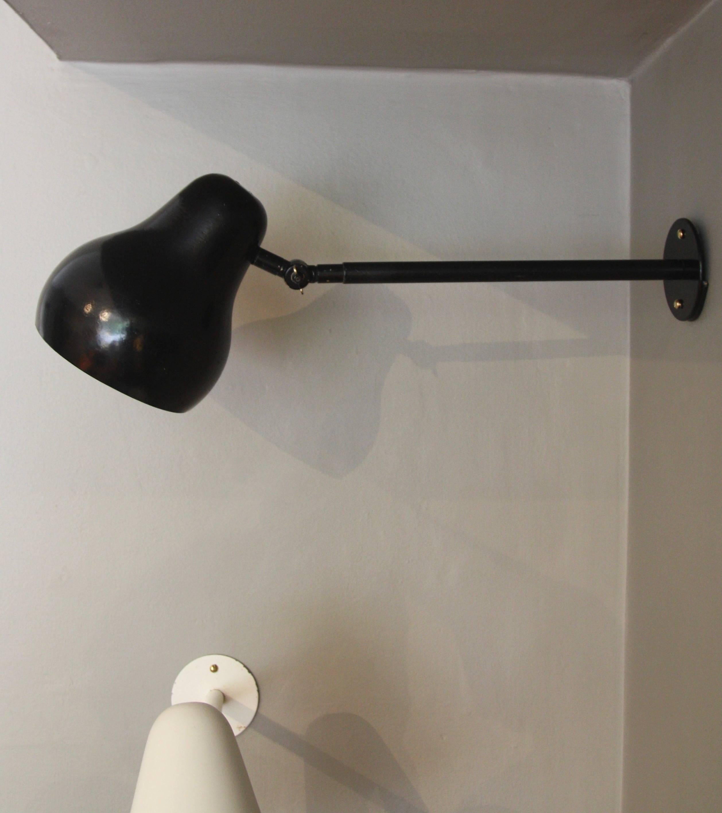 A wall-mounted lamp in black lacquer with adjustable shade designed by Vilhelm Lauritzen and manufactured by Louis Poulsen, circa early 1940s.
The light is newly wired and able to be fixed to a wall by two screws. There is a wing-nut on the neck of