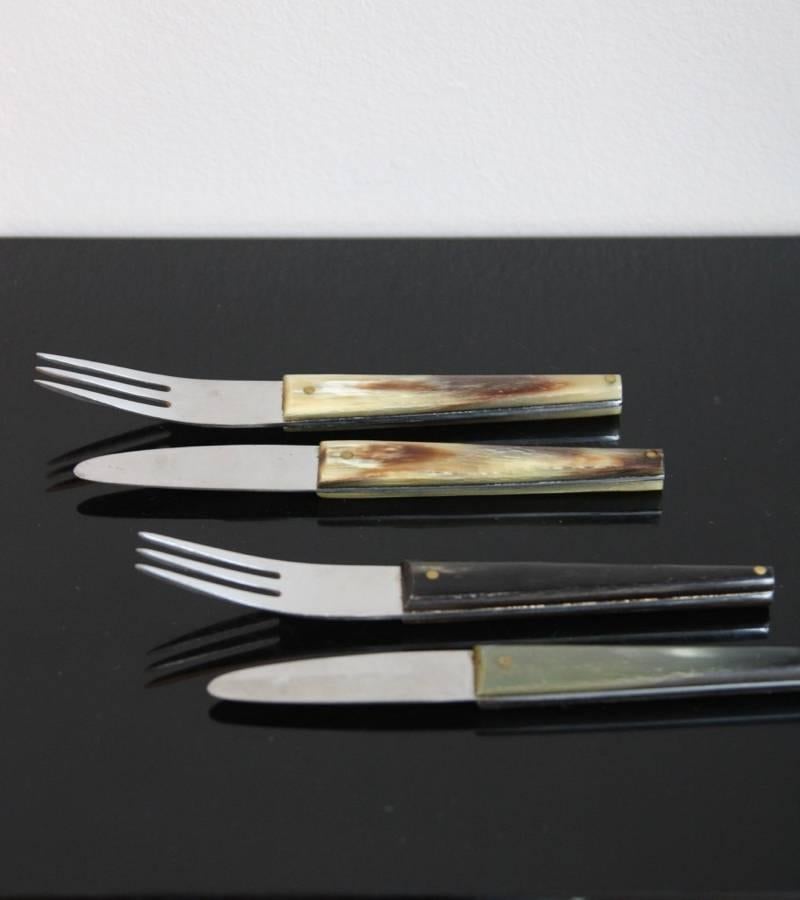 Vintage set of two forks and knives by Carl Auböck II, Vienna, circa 1950.
Each piece is made in stainless steel and covered by Horn varying in colour from dark green to off-white.
In overall excellent condition.