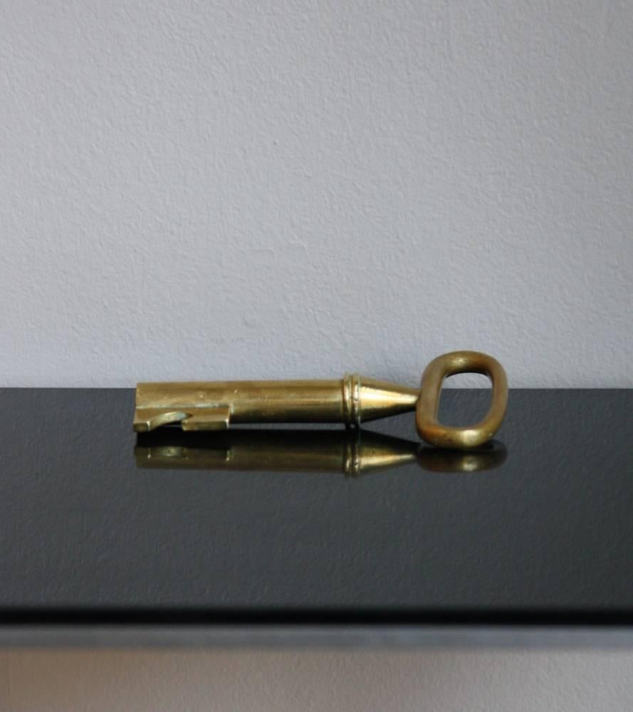 Large key corkscrew by Carl Auböck II, Vienna, circa 1950. 
Made in cast brass with the corkscrew in steel, the key is covered by a uniform and warm patina.
In overall very good condition.