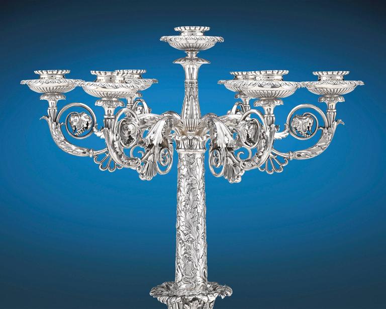 Elegantly designed by one of the most prominent names in silversmithing, this exceptional silver centerpiece by Paul Storr is perhaps the finest single candelabrum ever made by the famed silversmith. Profusely cast and chased with a blend of