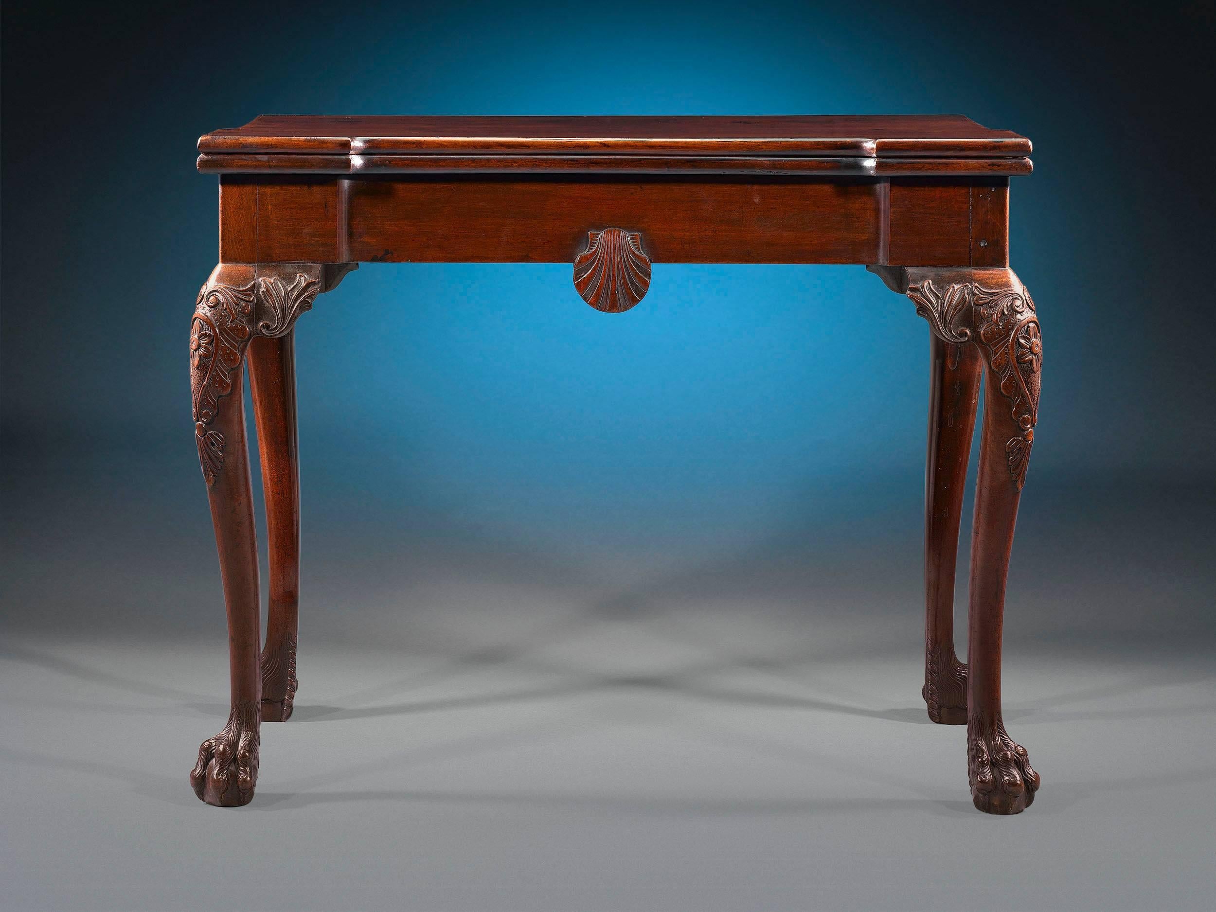 This exceptional Irish games table is as functional as it is beautiful. Crafted of Cuban mahogany, it serves as a console table when not in use, but the top folds out to reveal a green baize playing surface, supported by a gate leg, perfect for