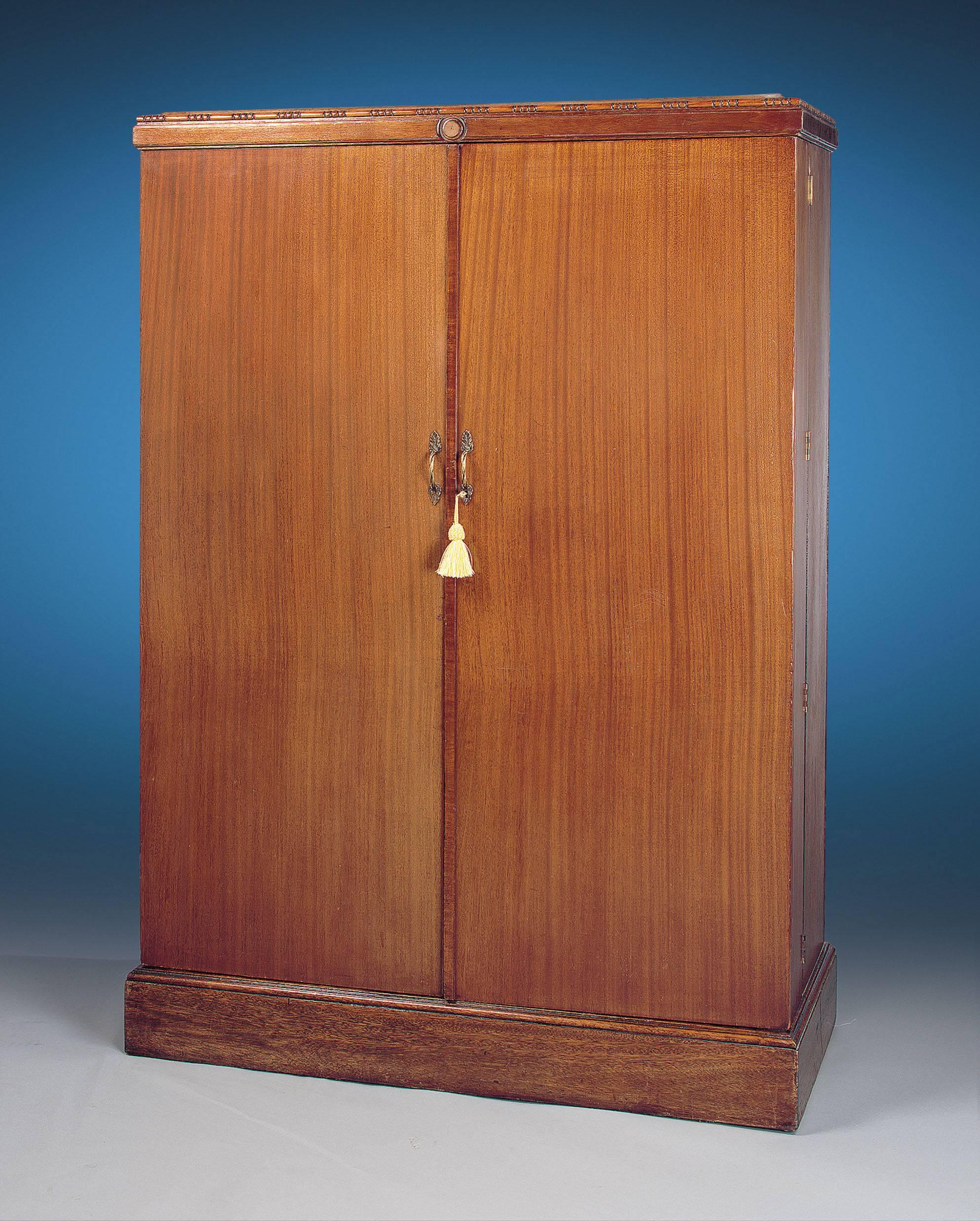 A wonderful ship's wardrobe patented by Compactom of London. This well-appointed traveling companion features storage compartments for everything necessary during an extended holiday. Just inside one of the doors is a Travel Reminder containing a