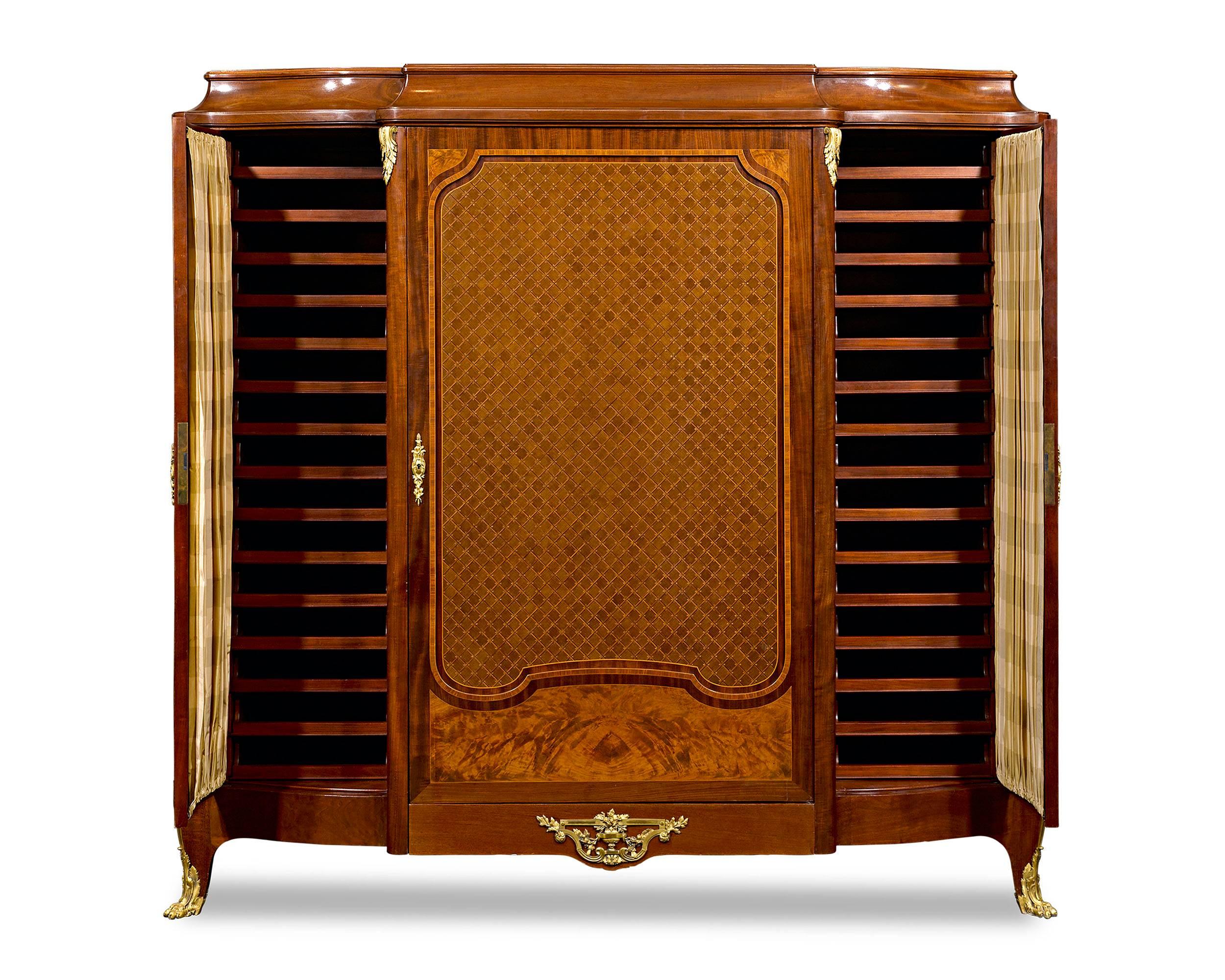 Sumptuous doré bronze and elaborate marquetry distinguish this important Louis XV-style mahogany library cabinet by Francois Linke, the most celebrated and influential ébéniste of the late 19th and early 20th centuries. Impeccable in both style and
