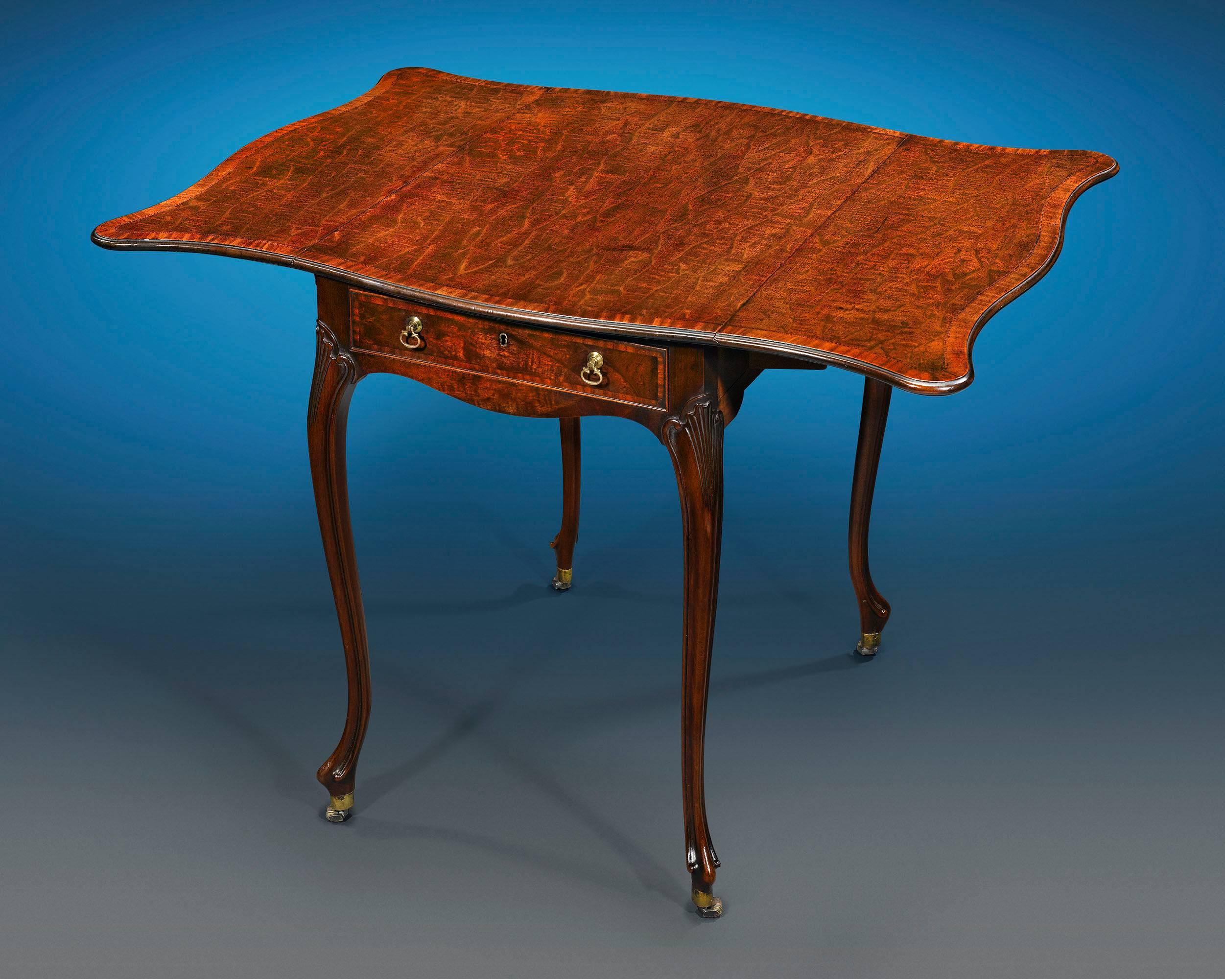 This highly important Pembroke table was crafted by the iconic Thomas Chippendale and is counted as one of the few rare examples made by his hand that are still in private hands. An unquestionable masterpiece, this mahogany and satinwood table also