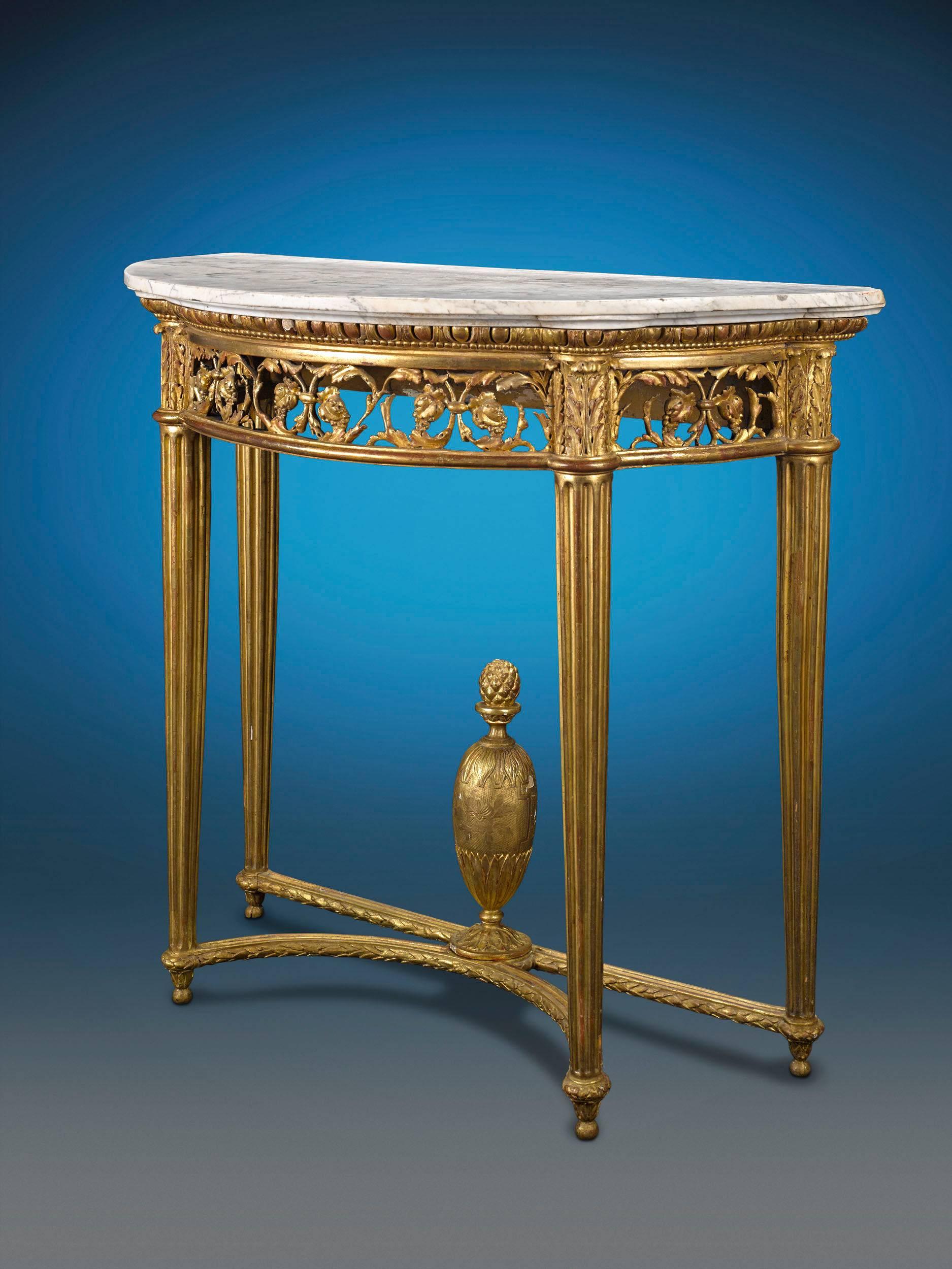 Fashioned in the Louis XVI style, this magnificent French console table has an opulent but classical feel. Crafted of luxurious giltwood with a marble top, this half-moon table is bedecked with Neoclassical mounts that accent the table's intricate
