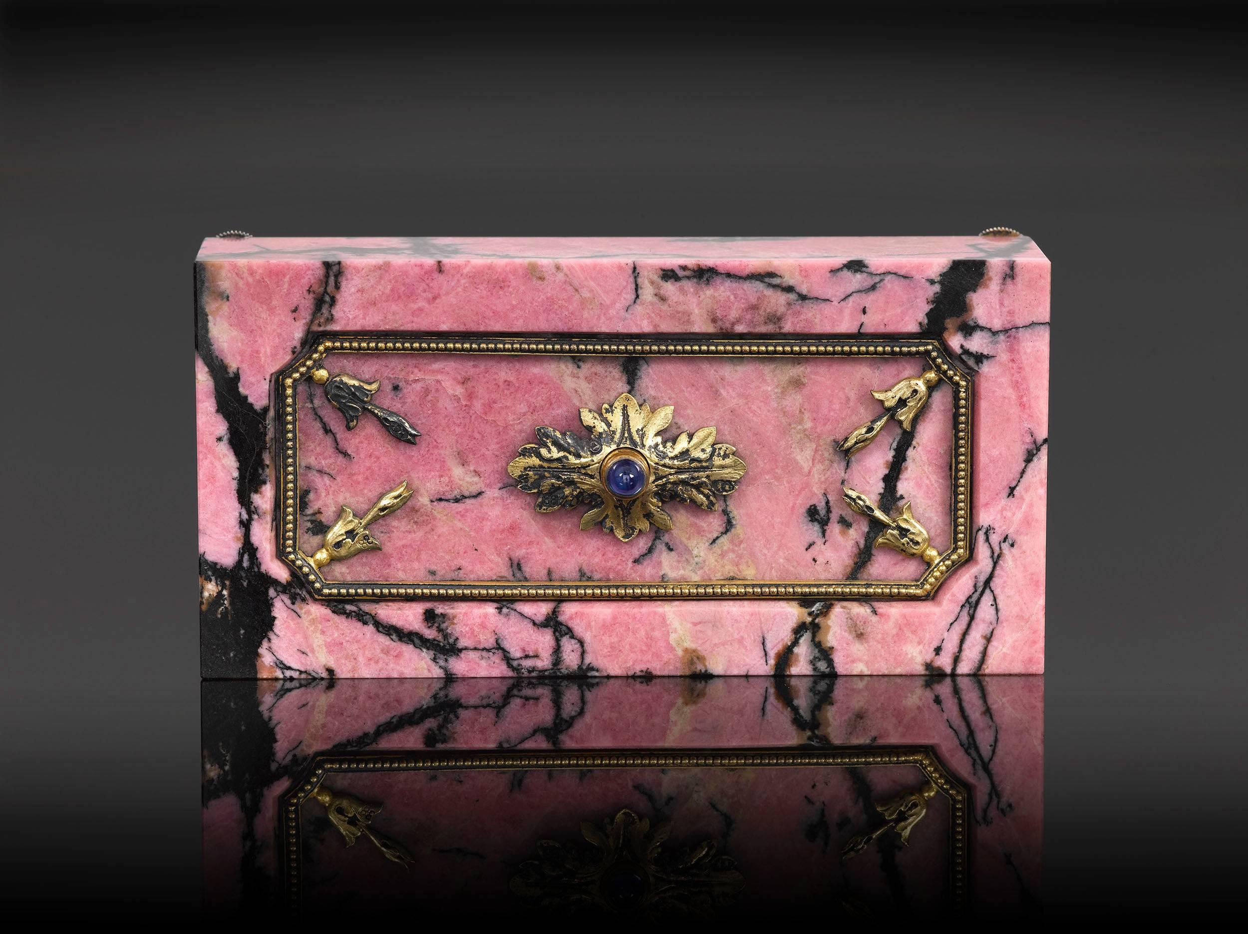 This stunning bell push was handcrafted by the masterful Carl Fabergé. The body of this elegant objet d'art is formed of beautiful rhodonite, and features the contrasting black-veined, rose-colored hues characteristic of the mineral. The decorative