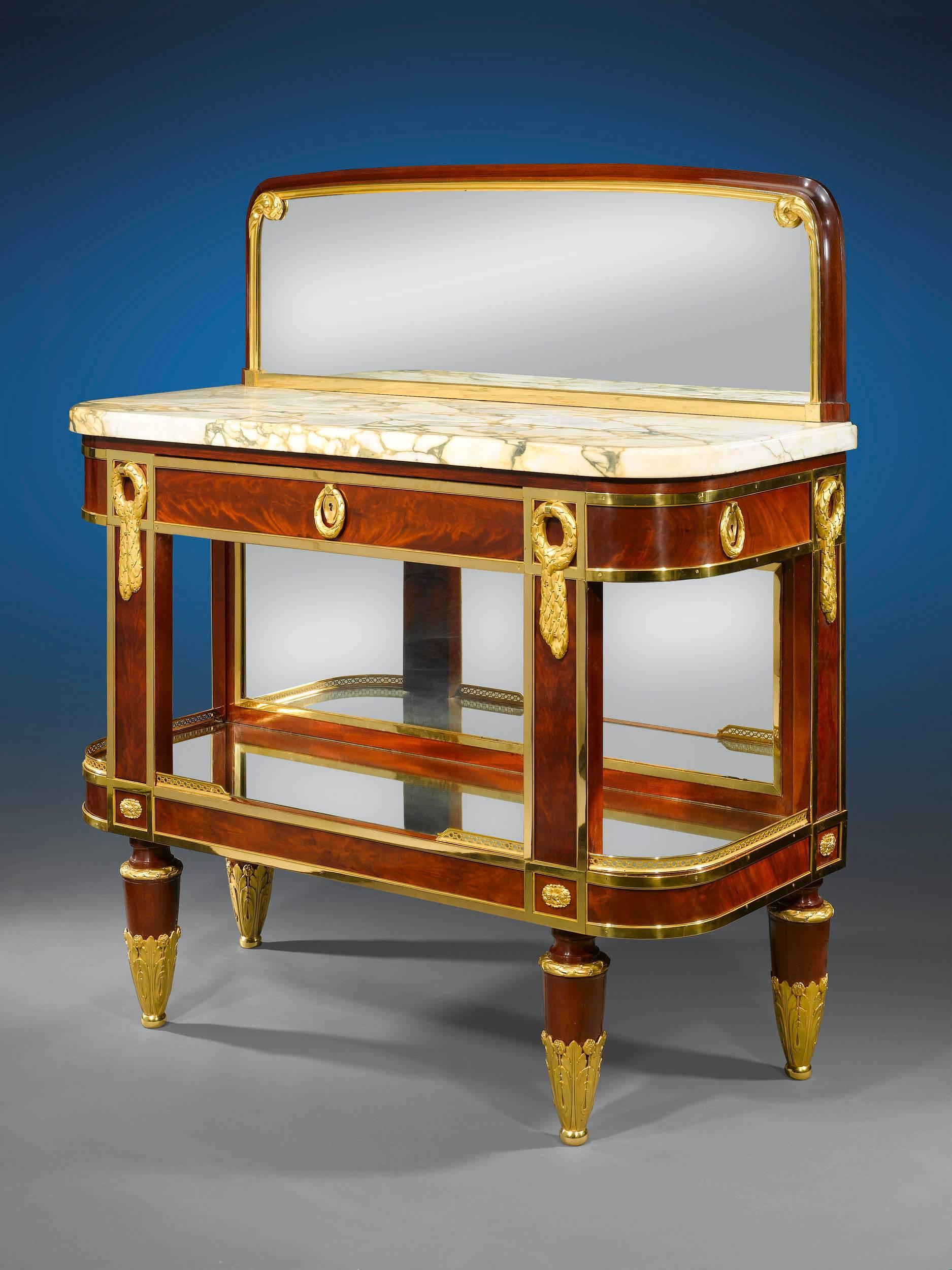 This magnificent French dining buffet cabinet captures the luxury of the Empire period in grand style. Crafted of exotic mahogany, the beautifully lacquered buffet features a fine marble top and mirrored backsplash. Intricately cast ormolu
