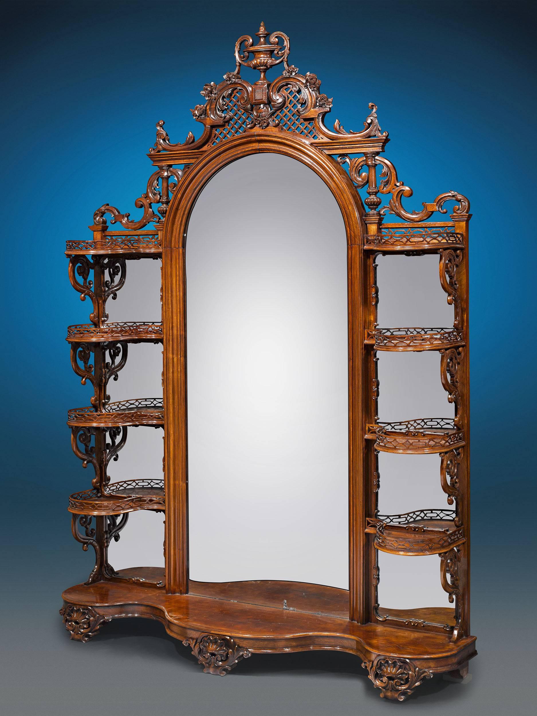 This magnificent rosewood American Rococo Revival étagère is attributed to Alexander Roux, a French immigrant to New York noted for his innovative and fashionable designs. This particular example boasts carving and open latticework along the