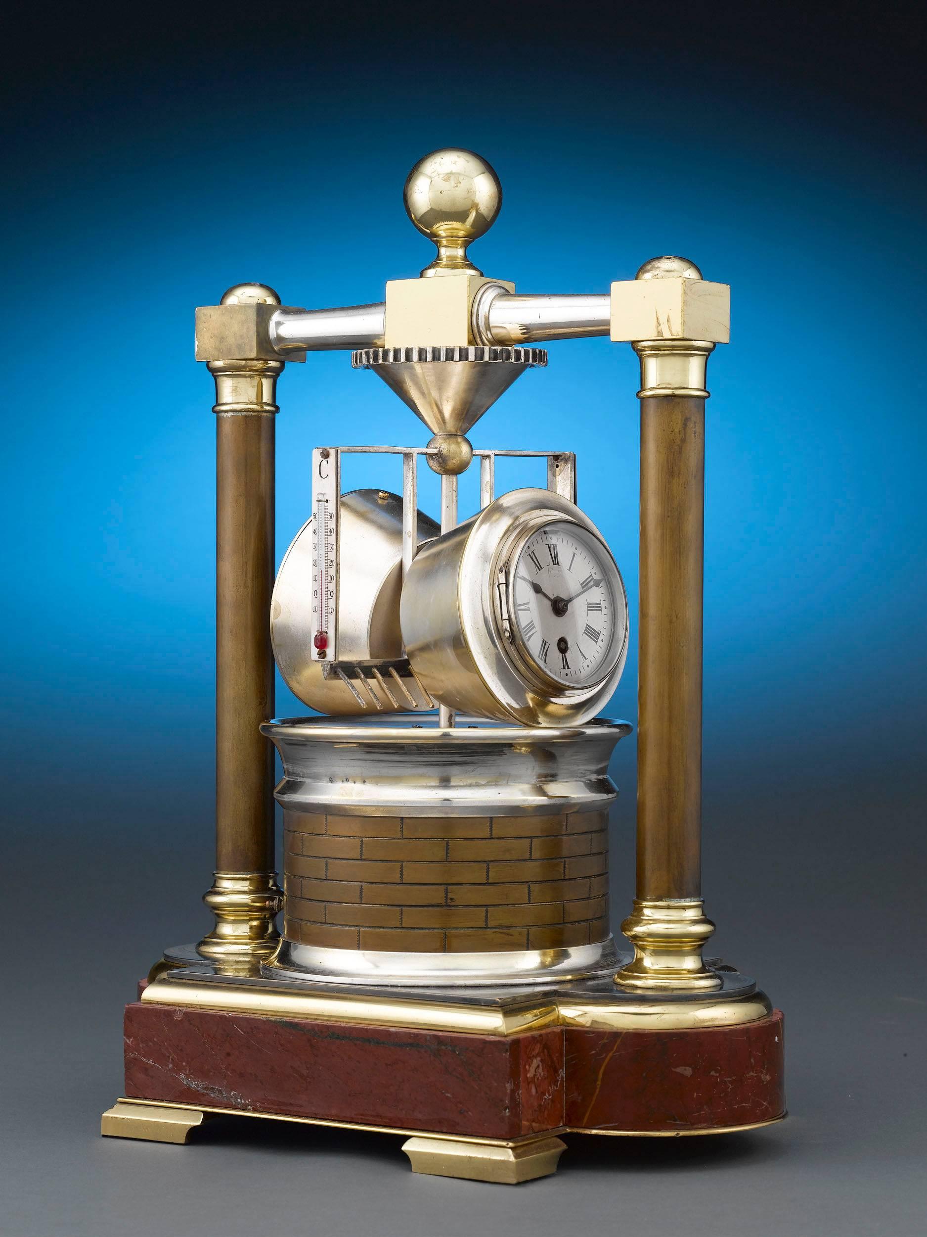 This stunning Industrial clock is crafted in the form of a horizontal grist mill. Crafted of silvered and gilt bronze, this intriguing instrument combines a spring-wound, silvered dial clock and aneroid barometer within its dual-barreled design, as