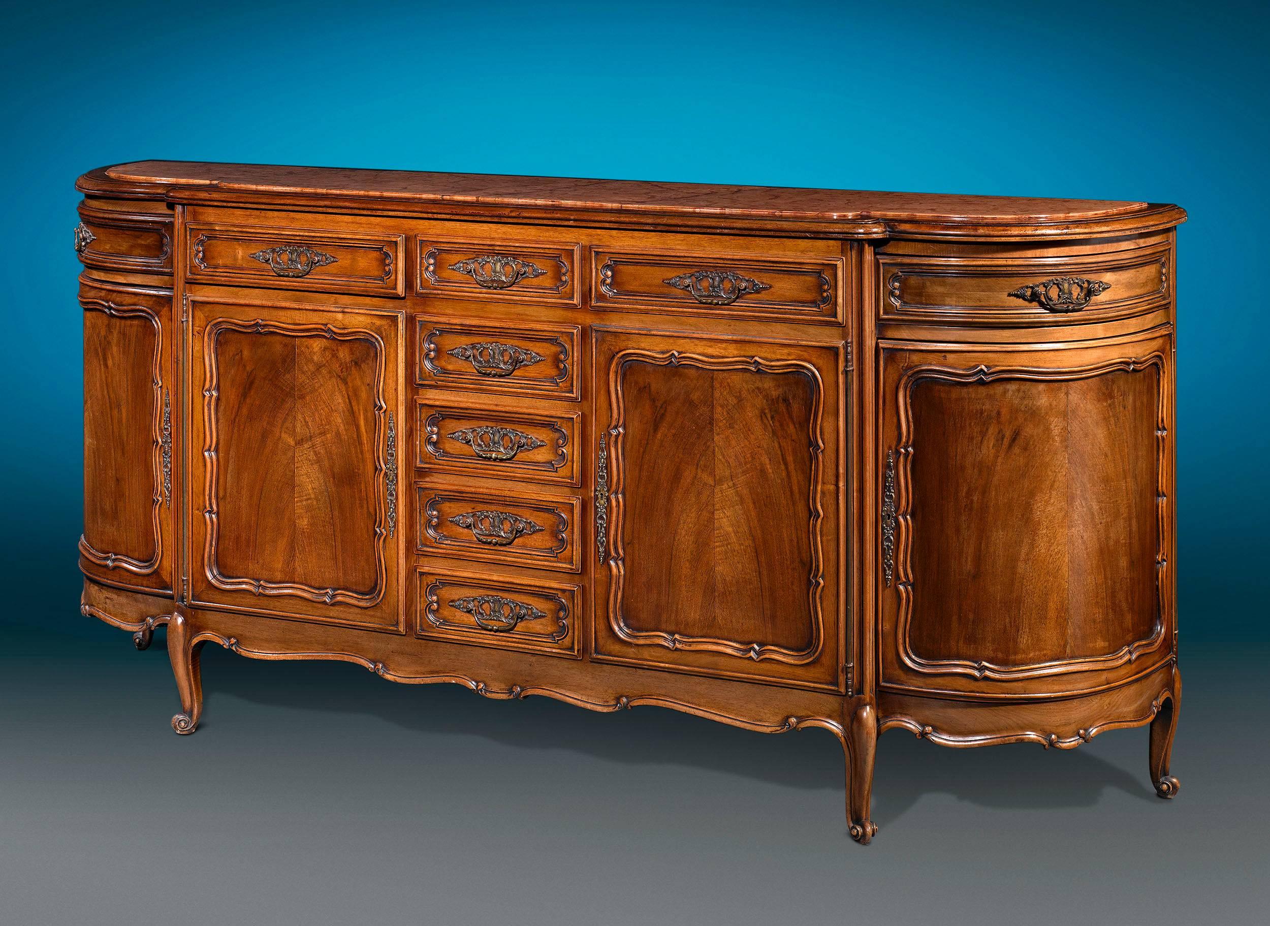 A lovely red marble top surmounts this highly desirable French Provincial buffet. Beautiful, robust carving details the exterior while the interior is fitted with shelves and drawers that are perfect for storing an array silverware and dining