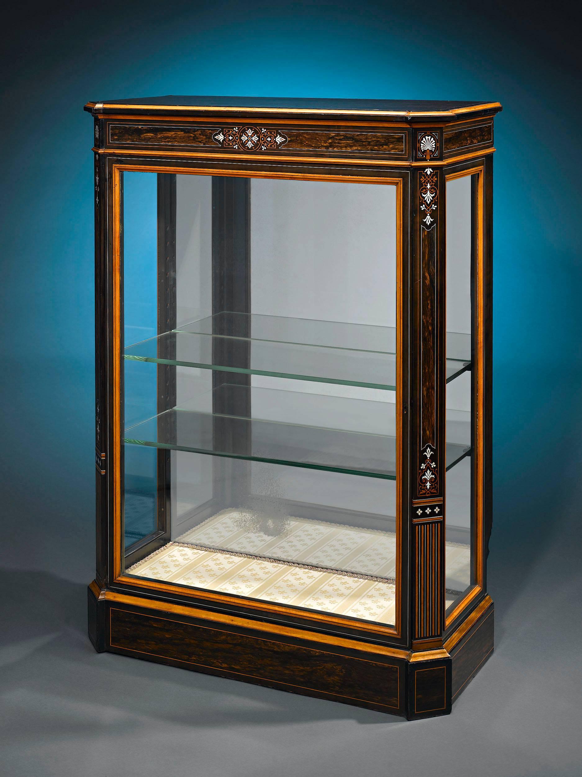 Highly-prized coromandel, or East Indian ebony, was used to create this beautiful Victorian vitrine. Featuring delicate inlay in the Victorian/Edwardian style and glass panels framed in the equally luxurious satinwood, this cabinet is constructed to