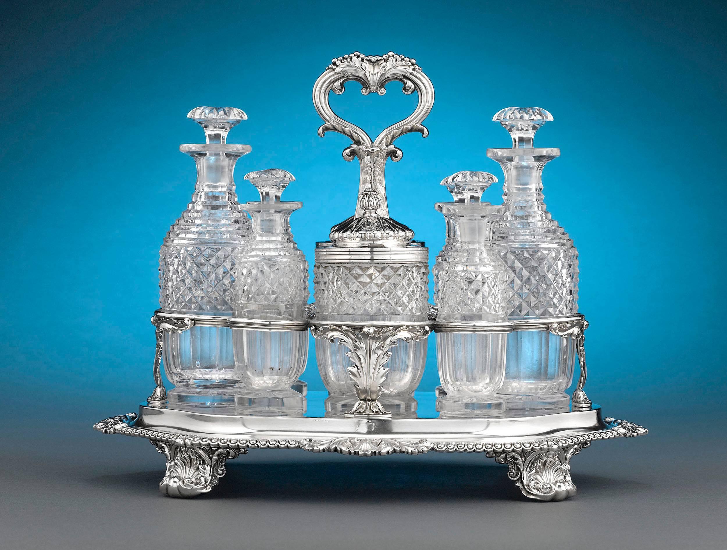 This important nine-piece Georgian silver and cut-glass cruet set by Paul Storr is an excellent example of the silversmith's remarkable Georgian work. The set consists of eight cut-glass bottles: two carafes for oil and vinegar, two mustard pots