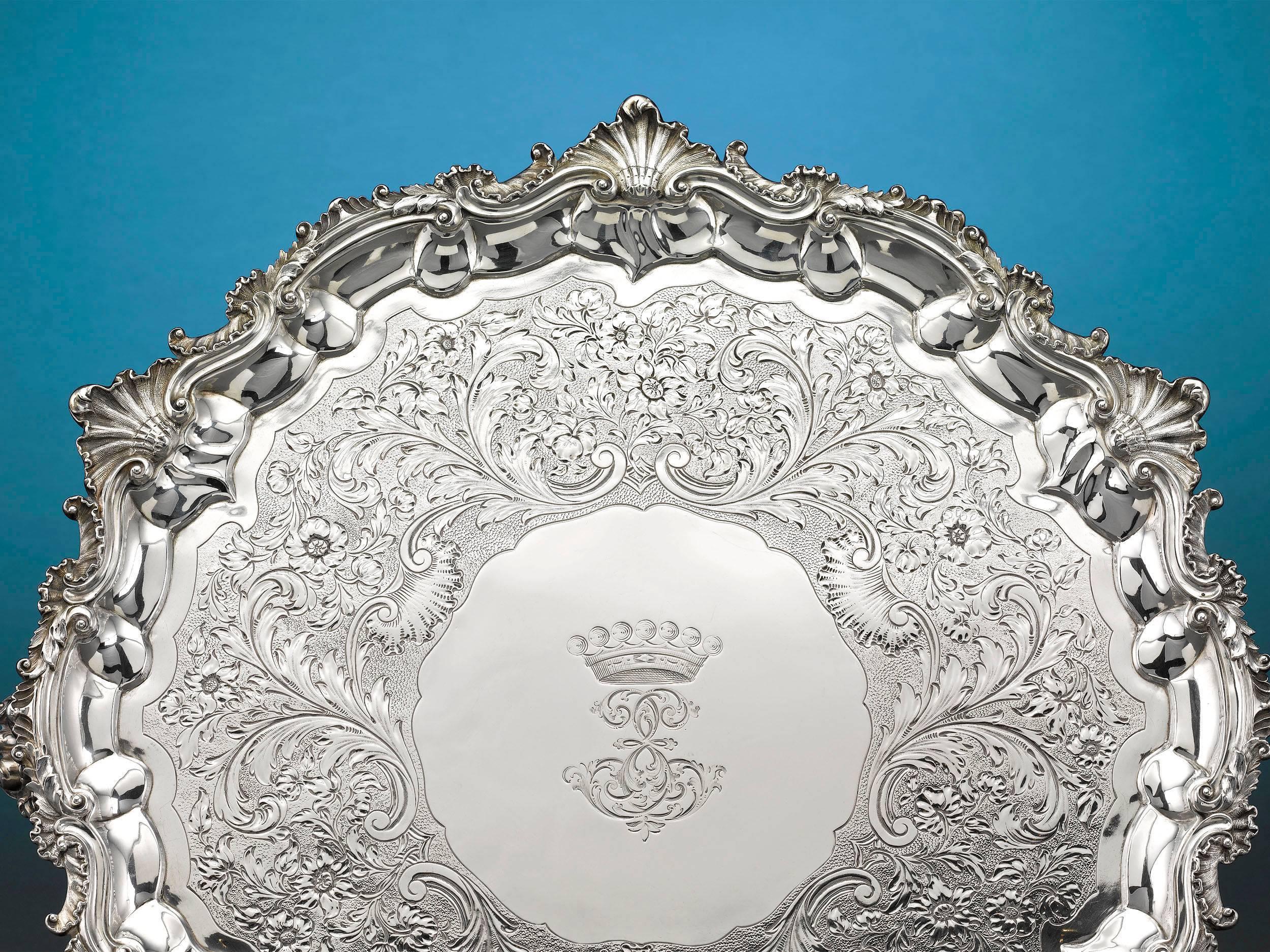 The classical elegance of this stunning Regency period silver tray is the signature of renowned silversmith Paul Storr. Adorned with a striking engraved border with a shell motif, this large William IV silver serving tray is also adorned with an
