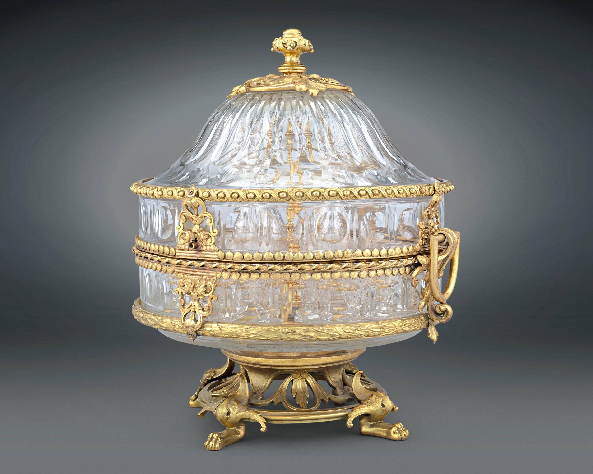 Doré bronze accents lend a touch of luxury to this stunning Napoleon III crystal cave à liqueur. The lush design embodies the abundance of the Napoleon III style, bringing together elements of the neoclassical and the Rococo Revival. An object of