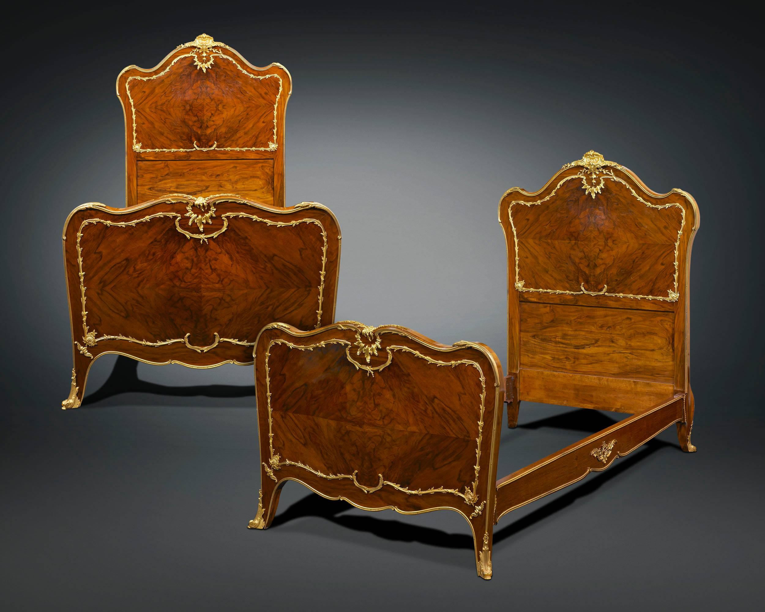 Superior craftsmanship and elegant adornment characterize these exceptional, matching pair of mahogany twin beds by François Linke, the most influential and distinguished French ébéniste of his time. Credited for designing highly innovative