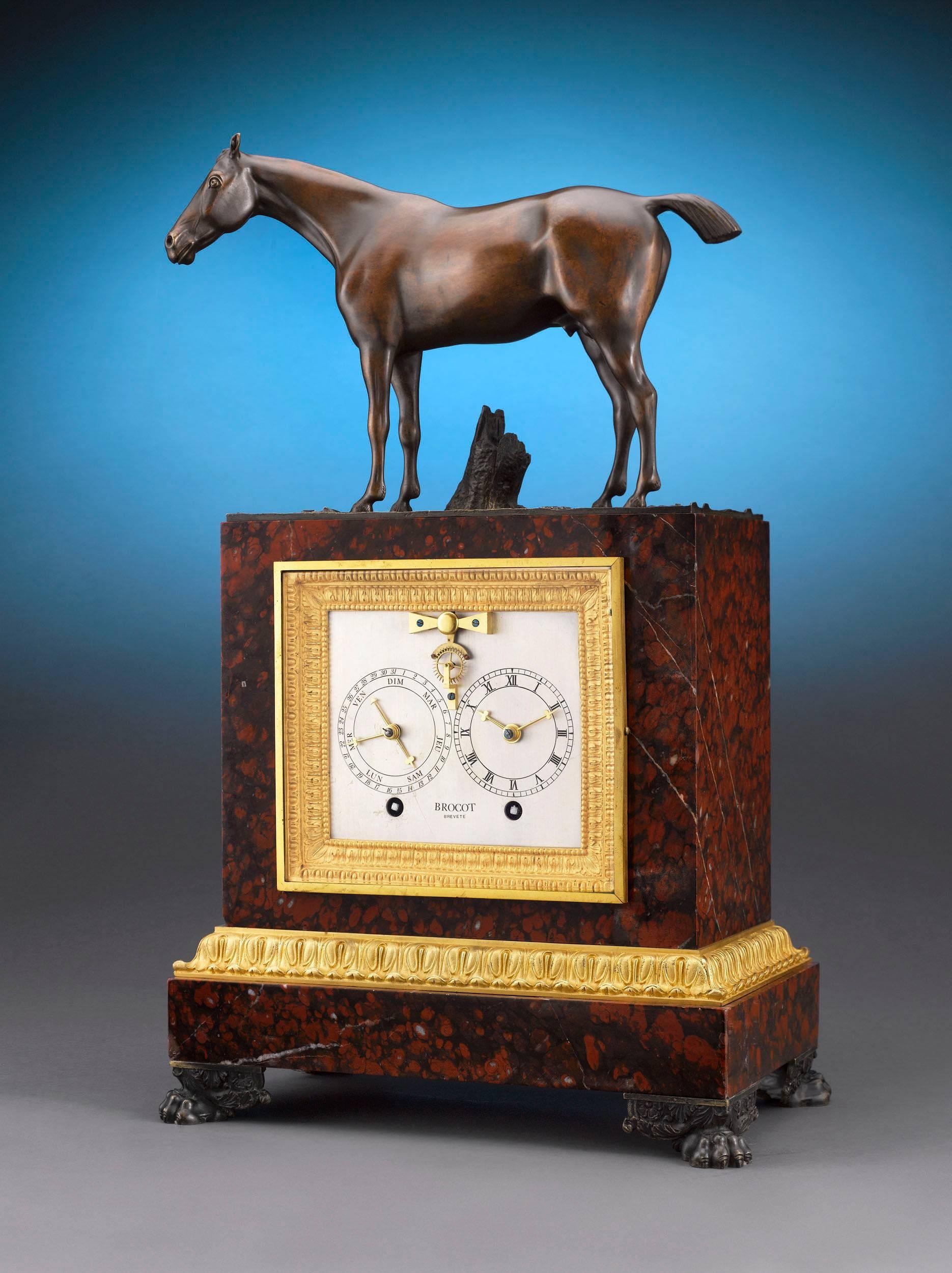 This highly important Napoleon III patinated bronze and rouge marble mantel clock by Louis-Gabriel and Achille Brocot is a work of mechanical and artistic beauty. Featuring a Brocot pin-lever escapement with ruby pallets for precise telling of time,