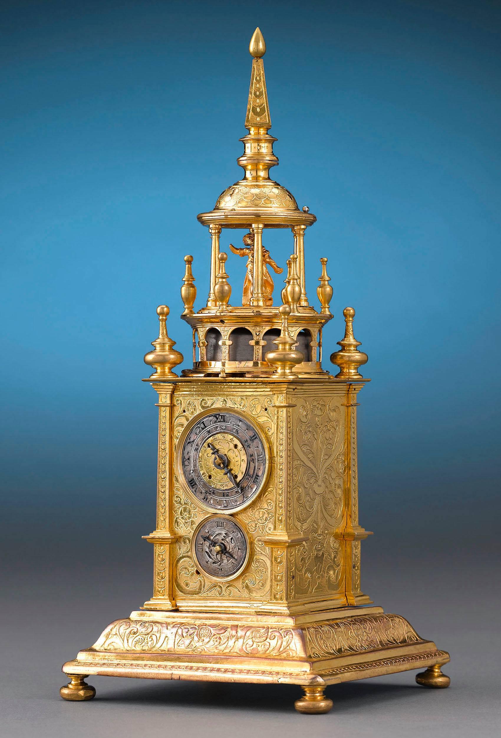 This immensely rare Renaissance turret-form clock, or table clock, was considered both a scientific marvel and an item of luxury during the period. This incredible piece is encased in fire gilt brass crafted to resemble the giant striking clocks set