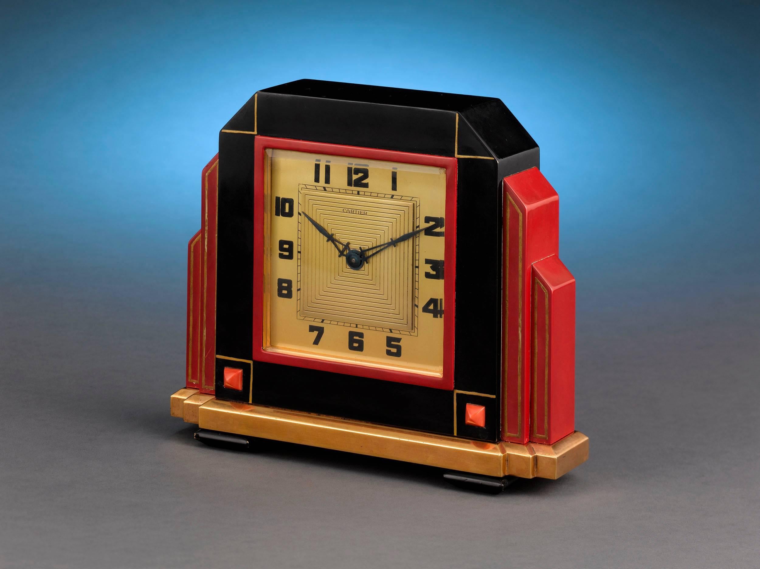 This rare and stylish clock by Cartier is the epitome of Art Deco design. This timepiece is housed in its sleek, architectural case, the black and red enameling reflecting Cartier's incredibly popular Oriental aesthetic, as imagined by legendary