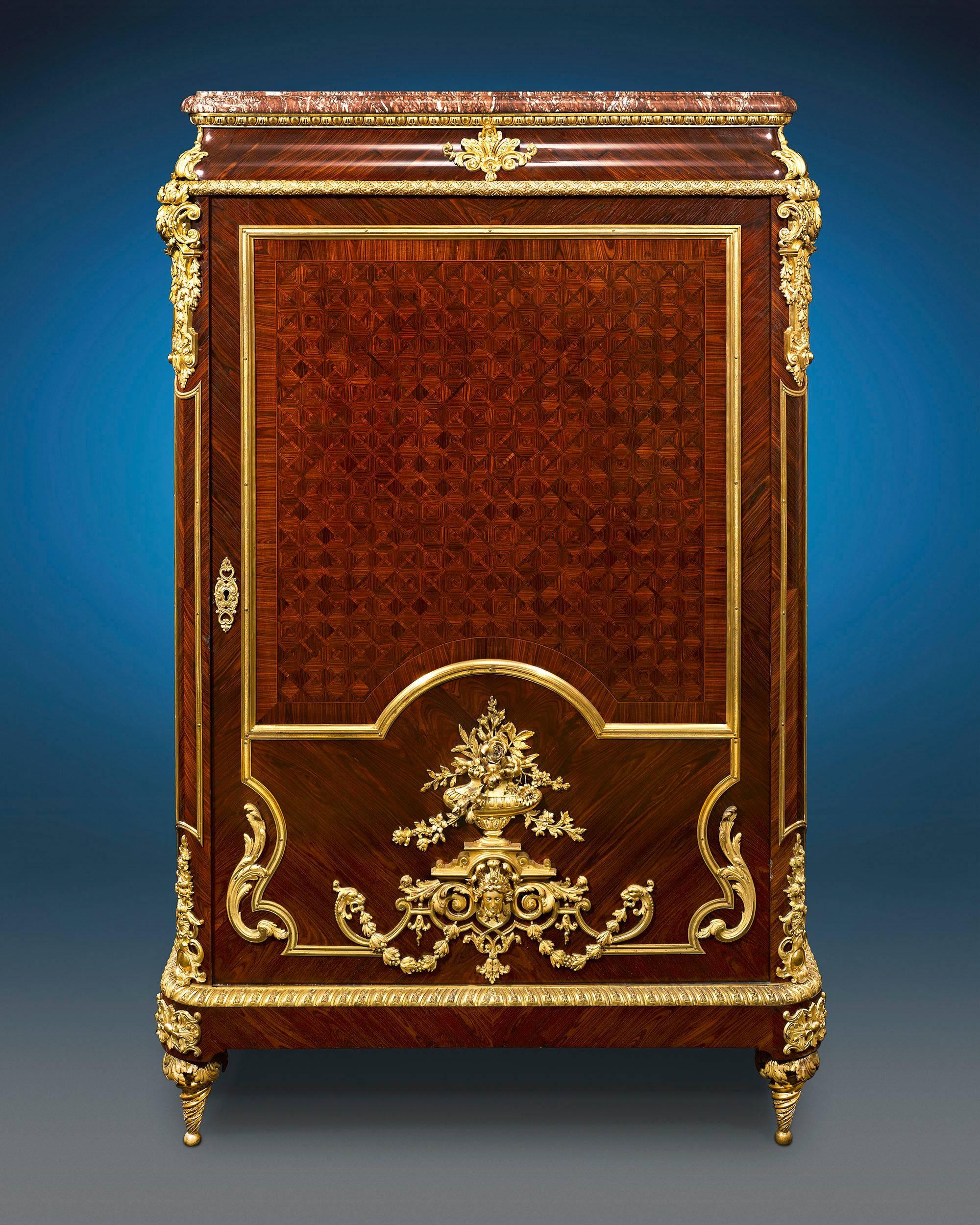 Enveloped in sumptuous parquetry and doré bronze, this majestic Louis XIV inspired French linen press displays the characteristics of superior craftsmanship and luxurious design seen in the creations of the iconic Françios Linke. Crafted of