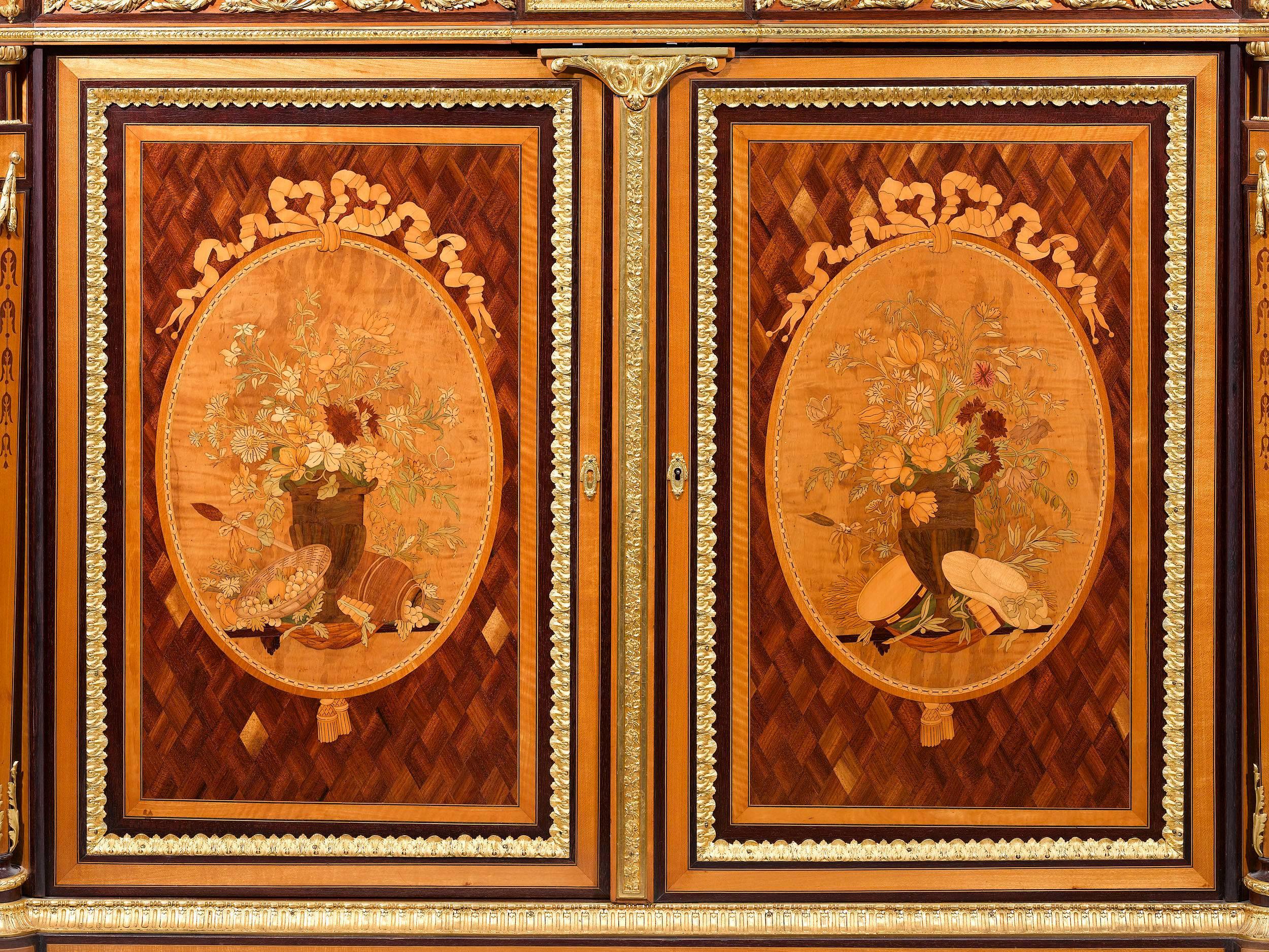 This pair of French inlaid cabinets displays an astonishing level of artistry and craftsmanship. Clearly the work of the most skilled artisans, the intricate doré bronze is almost certainly the work of legendary Parisian bronzier, Victor Paillard.