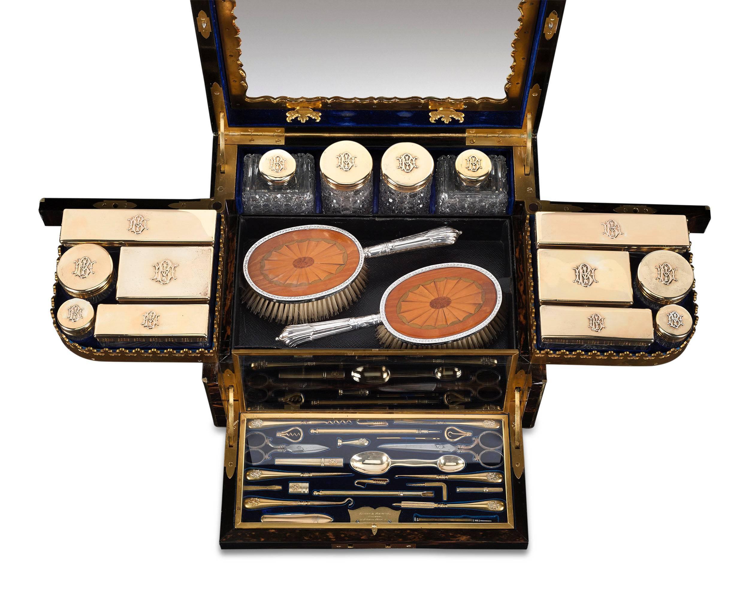 This phenomenal English coromandel nécessaire de voyage, crafted by Jenner & Knewstub, is among the finest vanity sets ever created. The gilt interior, lined with luxurious blue velvet, contains an impressive array of personal accouterments, all