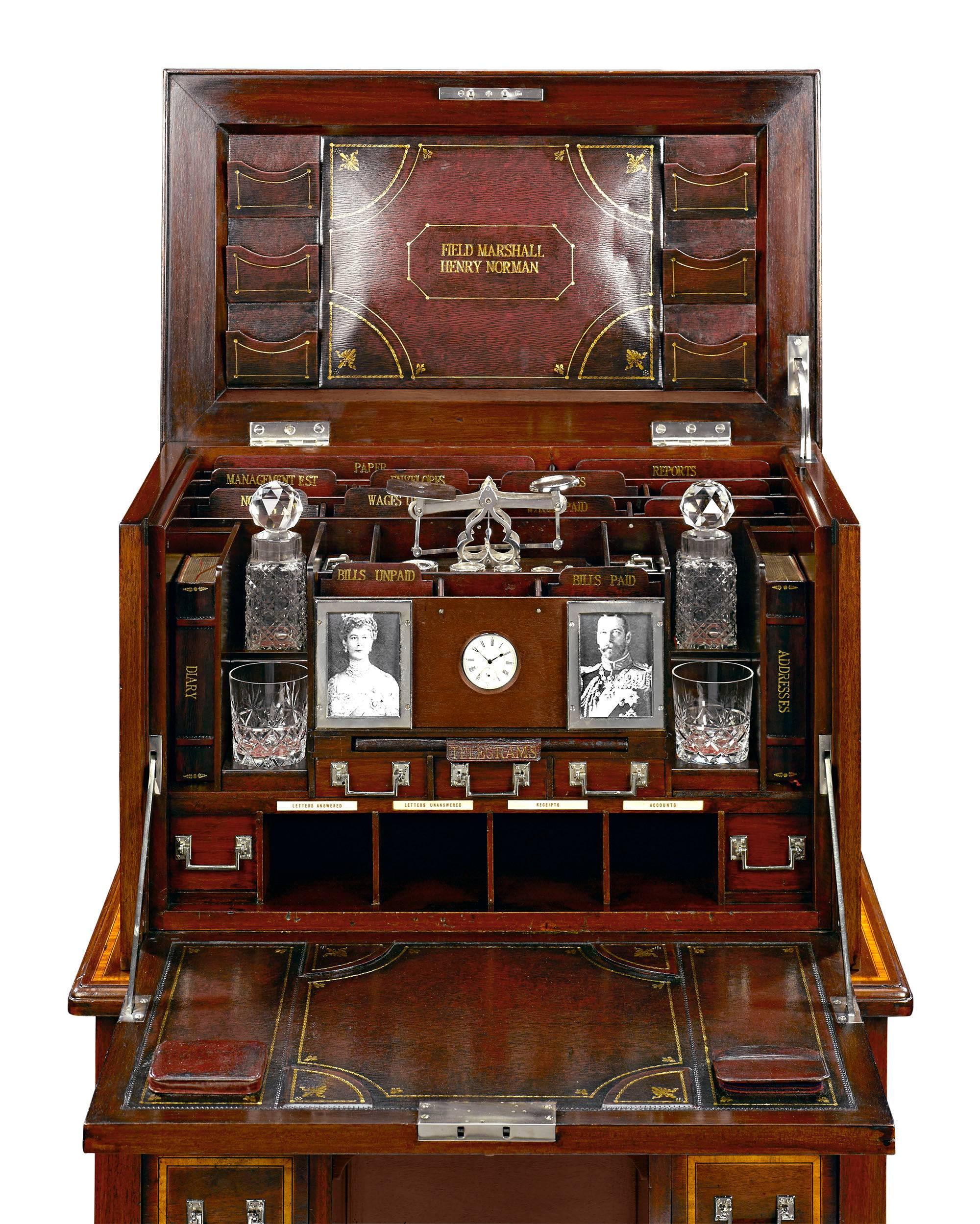 This extraordinary and rare English desk is an impeccable example of English Campaign furniture. Crafted of mahogany, this compact desk was given to Field Marshal Sir Henry Wylie Norman, a British Colonial administrator and senior officer of the