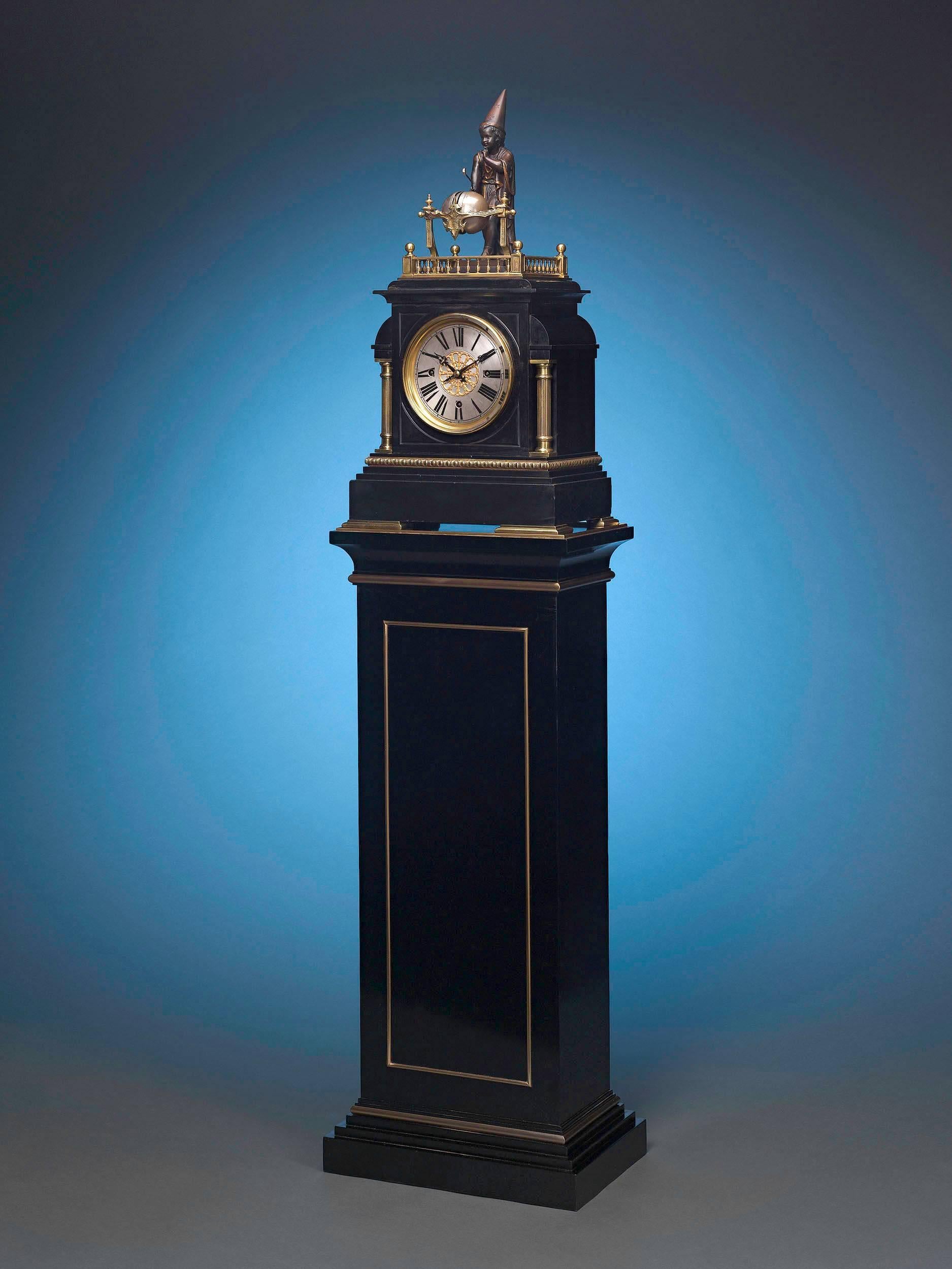 This incredibly rare automaton clock is surmounted by a charming young wizard. On the quarters of the hour, he sounds the time on four Westminster chimes with a Hammer held in his right hand. The bells of this intriguing piece are housed in a