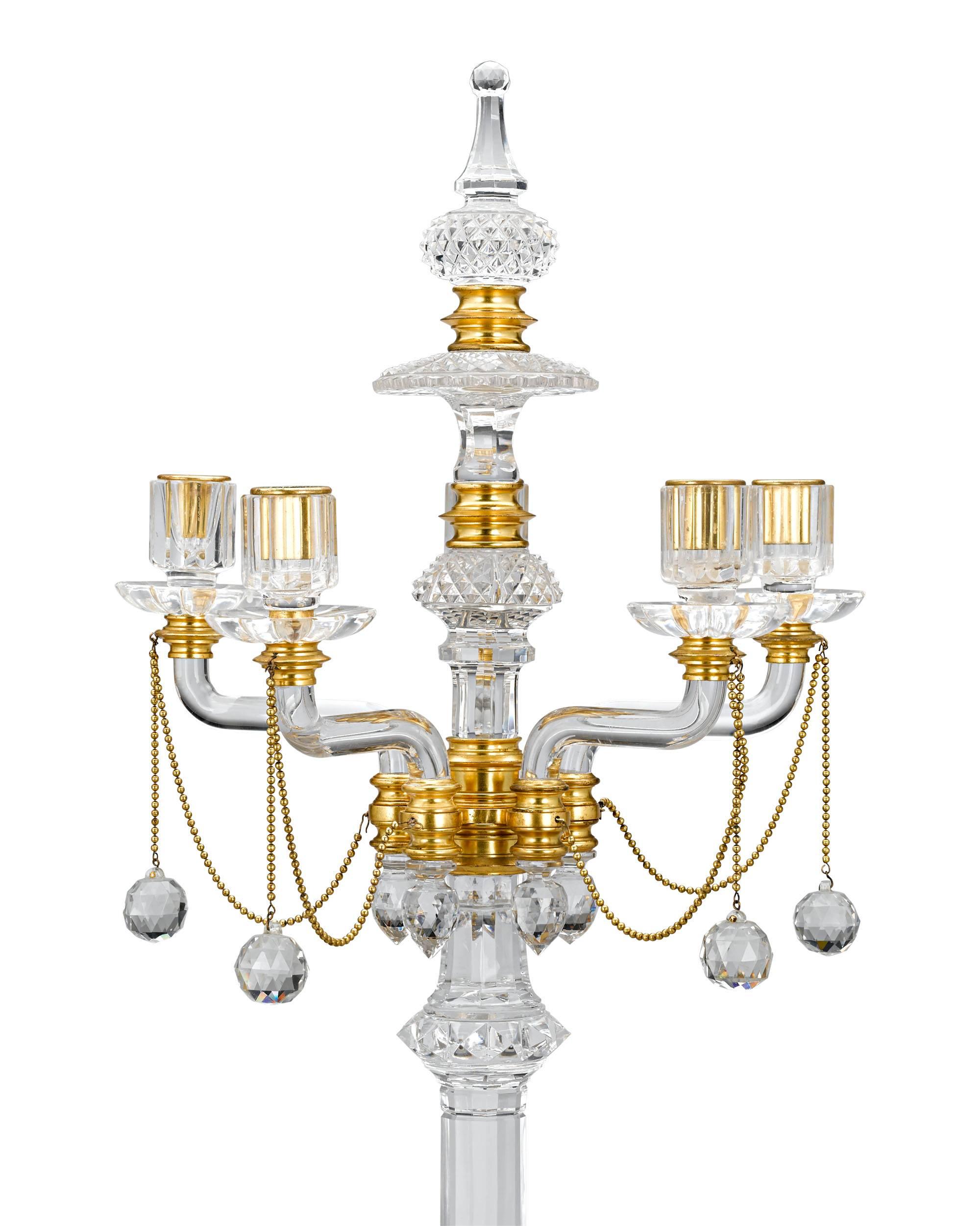 This extraordinary pair of cut-glass and gilt bronze five-light candelabra was crafted by the celebrated crystal works of F. & C. Osler. The English firm was the largest and grandest manufacturer of glass in Victorian Britain, producing some of the