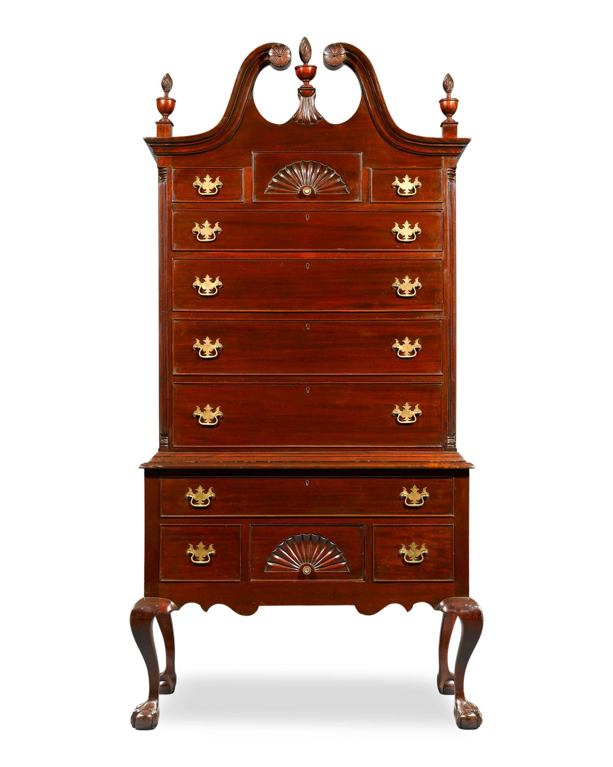 Subtle, yet impressive details adorn this rare and important Queen Anne style highboy chest-on-chest. Crafted of sturdy mahogany, this elegant chest displays all the hallmarks of the iconic Queen Anne style. The cresting wave of the broken pediment
