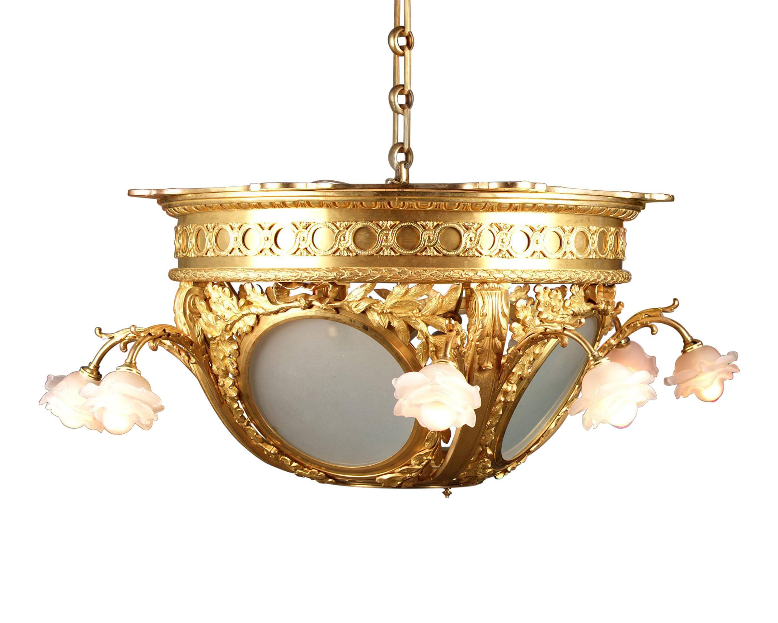 An absolutely stunning French doré bronze chandelier with four double-light frosted glass rosette shades and a central frosted glass dome. Scrolls of acanthus leaves enhance the gilded bronze dome, which lies over the frosted glass. Luxuriously