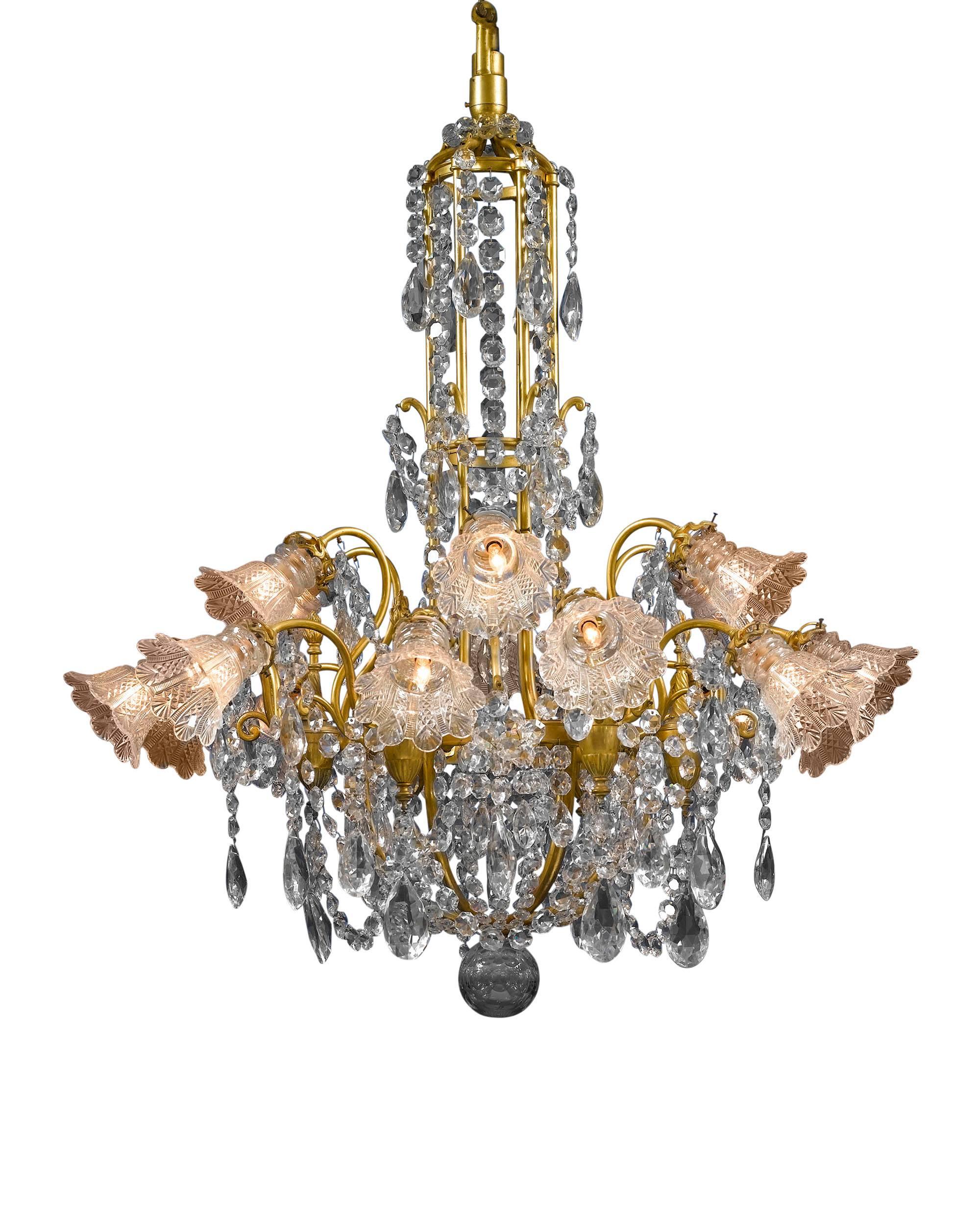 This Baccarat crystal and doré bronze chandelier of monumental size and opulent design is truly a splendid sight to behold. Hundreds of beautifully designed oversized, luminous prisms and beads of Baccarat crystal hang from scrolling branches of