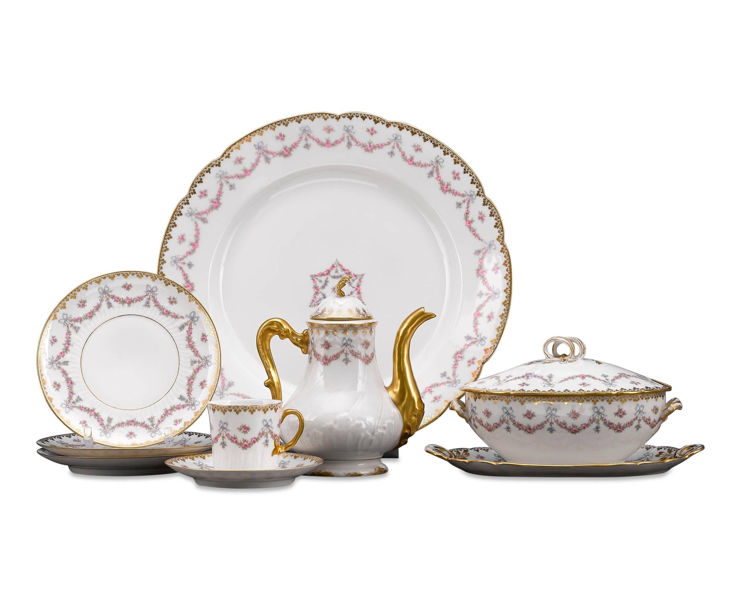 Delicate floral garlands and shimmering gilt accents distinguish this exceptional, 143-piece Limoges porcelain dinner service. Crafted by Gerard, Dufraisseix & Abbot, one of the most respected makers of Limoges porcelain, this beautiful service