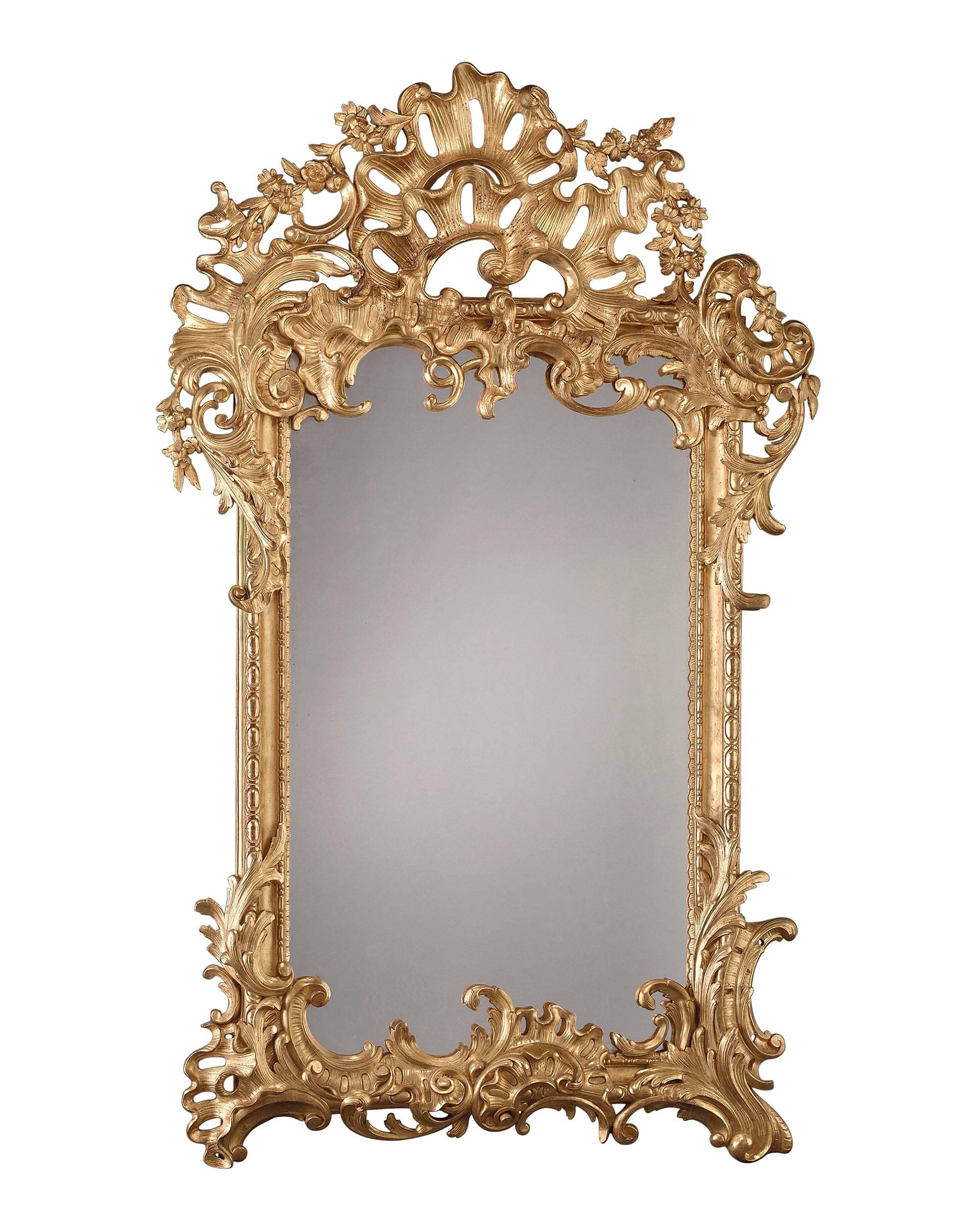 A spectacular French mirror of grand proportion expertly carved of giltwood in an attractive asymmetrical Rococo design. Excellent condition, circa 1870.