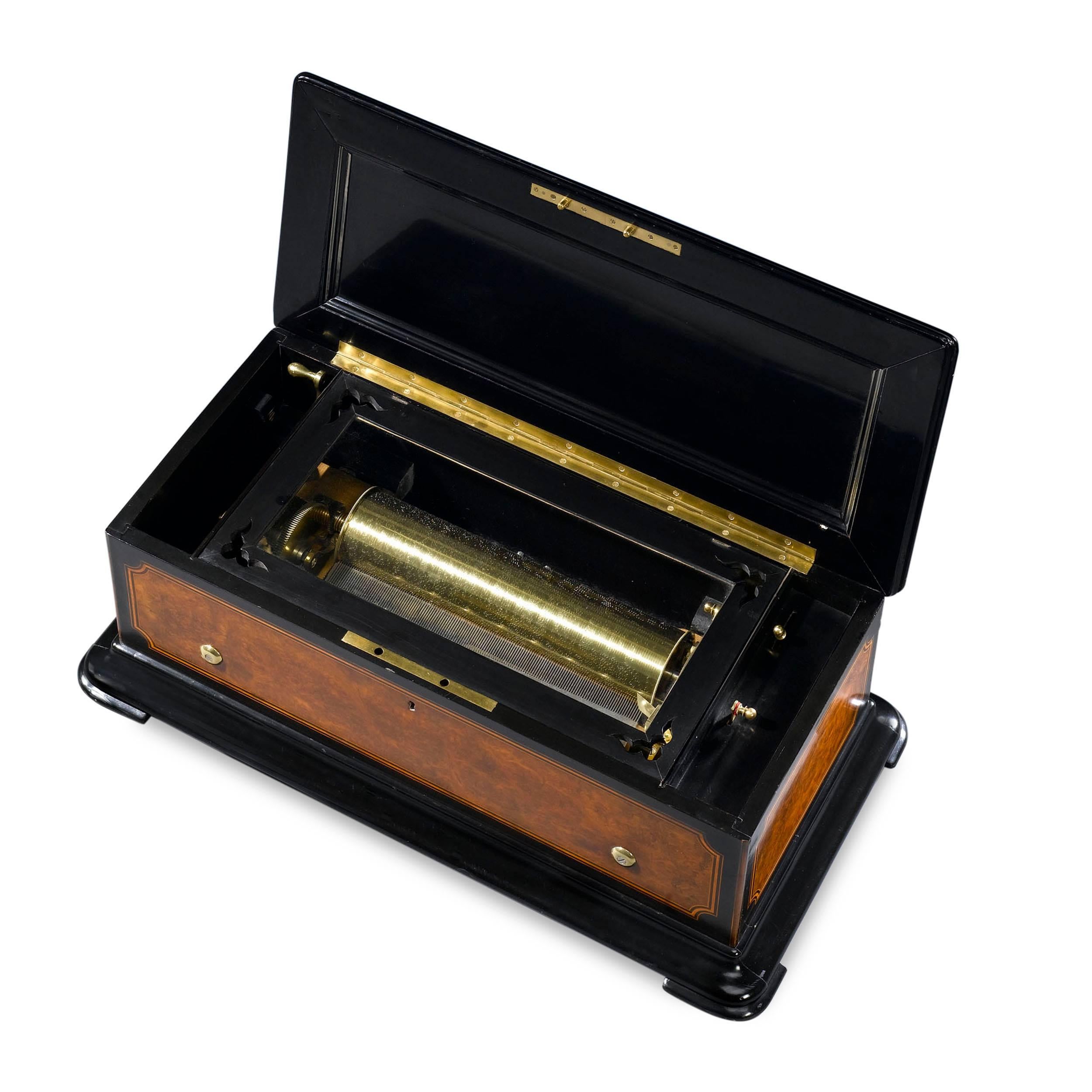 This music box manufactured by Brémond, one of the most respected and talented makers of the era, demonstrates not just beauty and technical excellence, but sheer musical mastery. The outer case boasts a burr-walnut veneer with ebony borders and