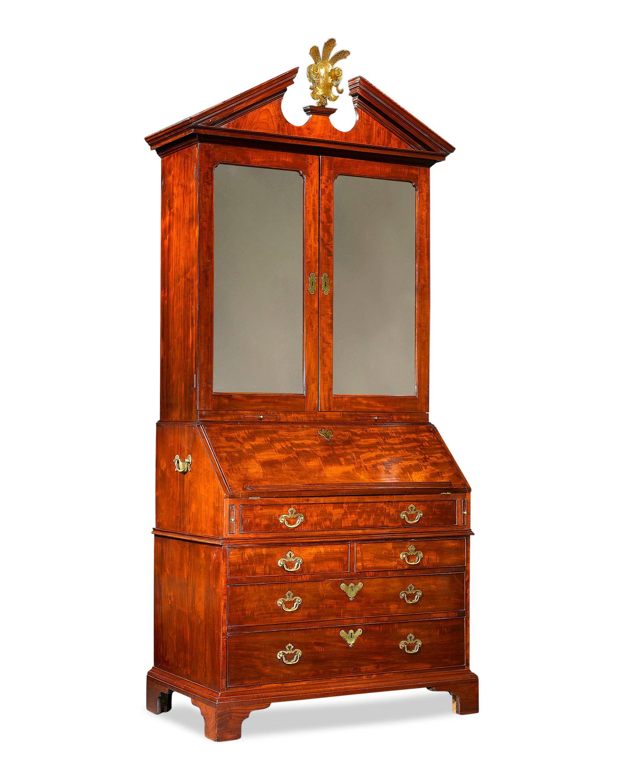 This exceptional Georgian secrétaire-cabinet was crafted in the style of Thomas Chippendale and displays both the scale and perfect proportions for which Chippendale furniture is renowned. Crafted of luxurious mahogany, the secrétaire is as