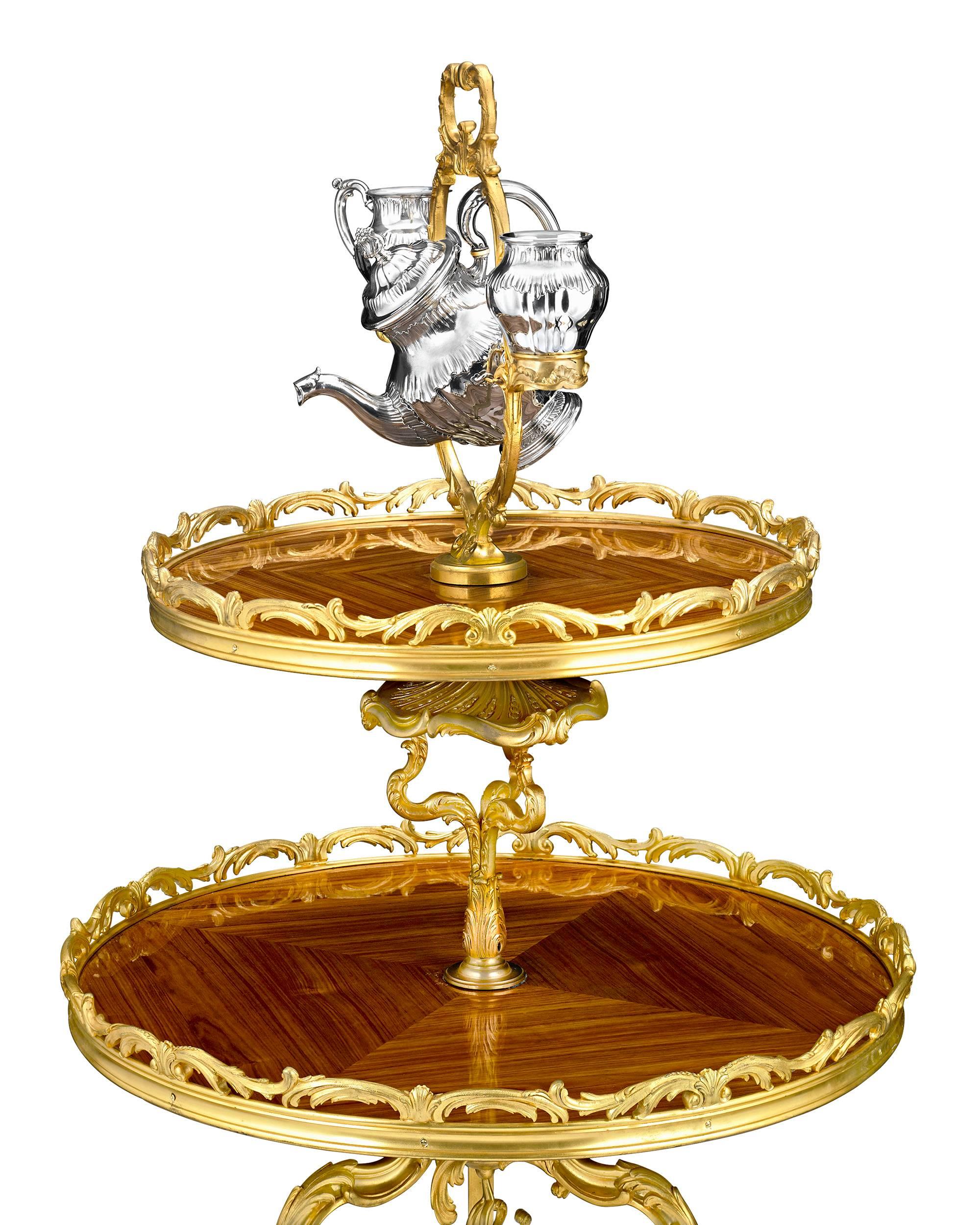 This exquisite tea table by celebrated Parisian silversmith Gustave Keller is an extraordinary example of superior French craftsmanship. The luxurious two-tiered table brings together exceptional metalwork and an ingenious design, with a stunning