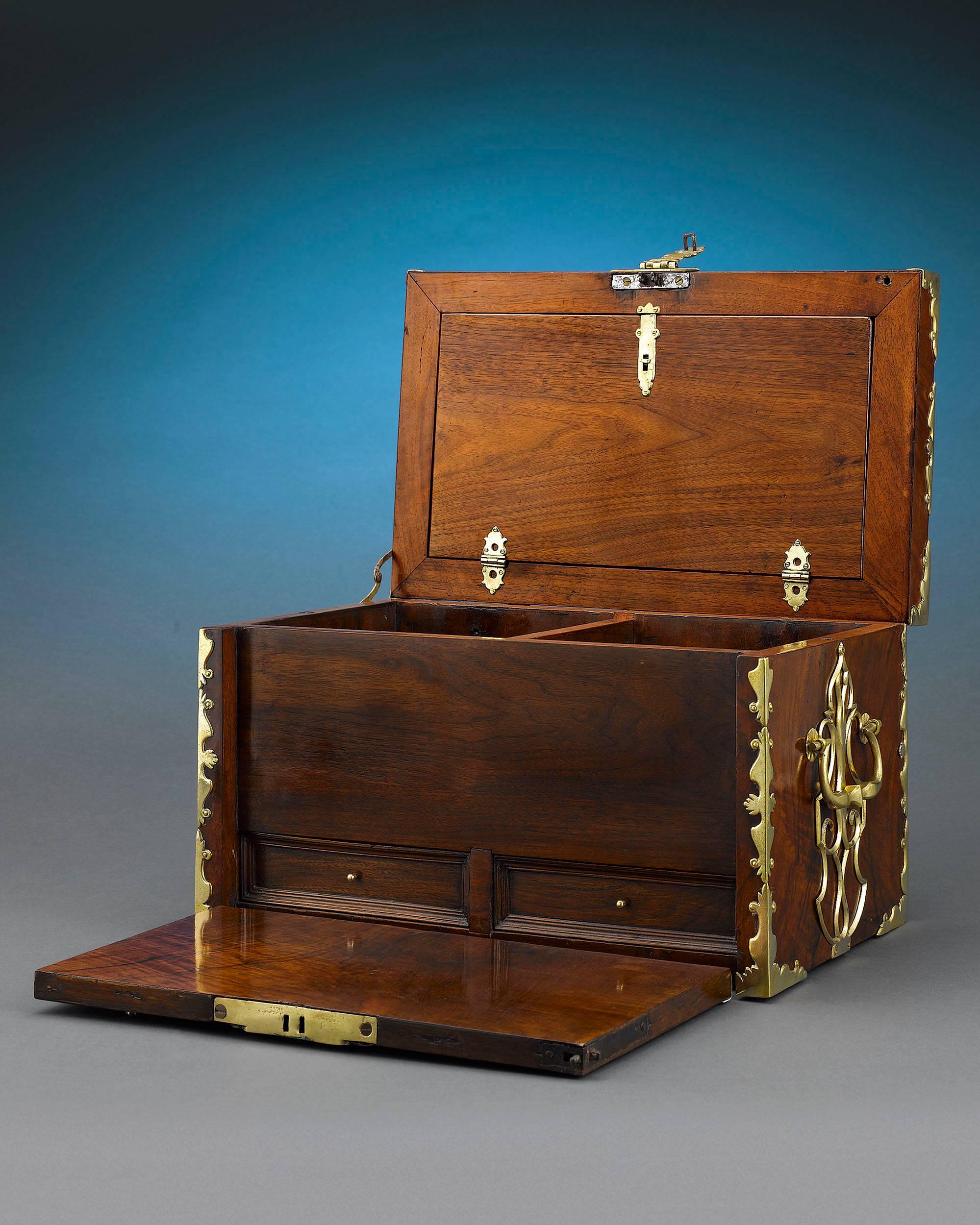 This impressive and rare British strong box is as versatile as it is beautiful. Crafted from a luxurious walnut veneer, it can be used as a jewelry box, as a humidor for one’s finest cigars, or to secure other valuable trinkets and treasures. The