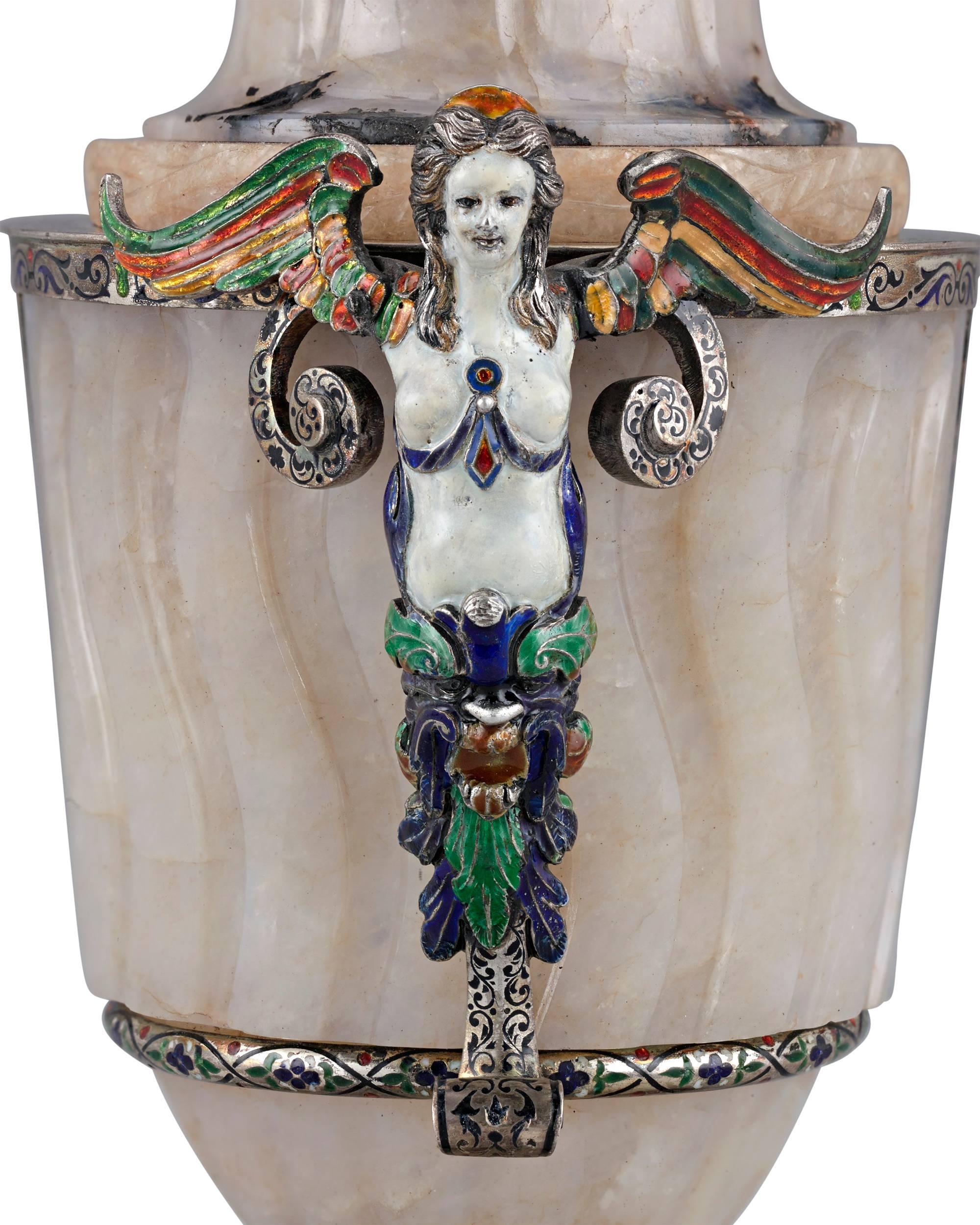 A glorious example of 19th century Viennese craftsmanship, this beautiful covered urn is hand-wrought from exquisite agate. Majestic silver mounts feature brilliant enameling of exceptional quality, with a pair of figural handles in the form of