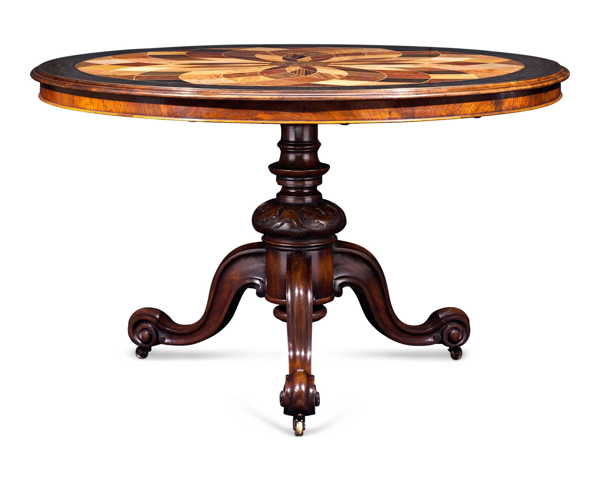 Fifty varieties of luxurious wood form the surface of this extraordinary English veneer sample table. Each specimen is inlaid into a stunning mirrored medallion design that beautifully displays its unique coloring and grain, while inlaid brass